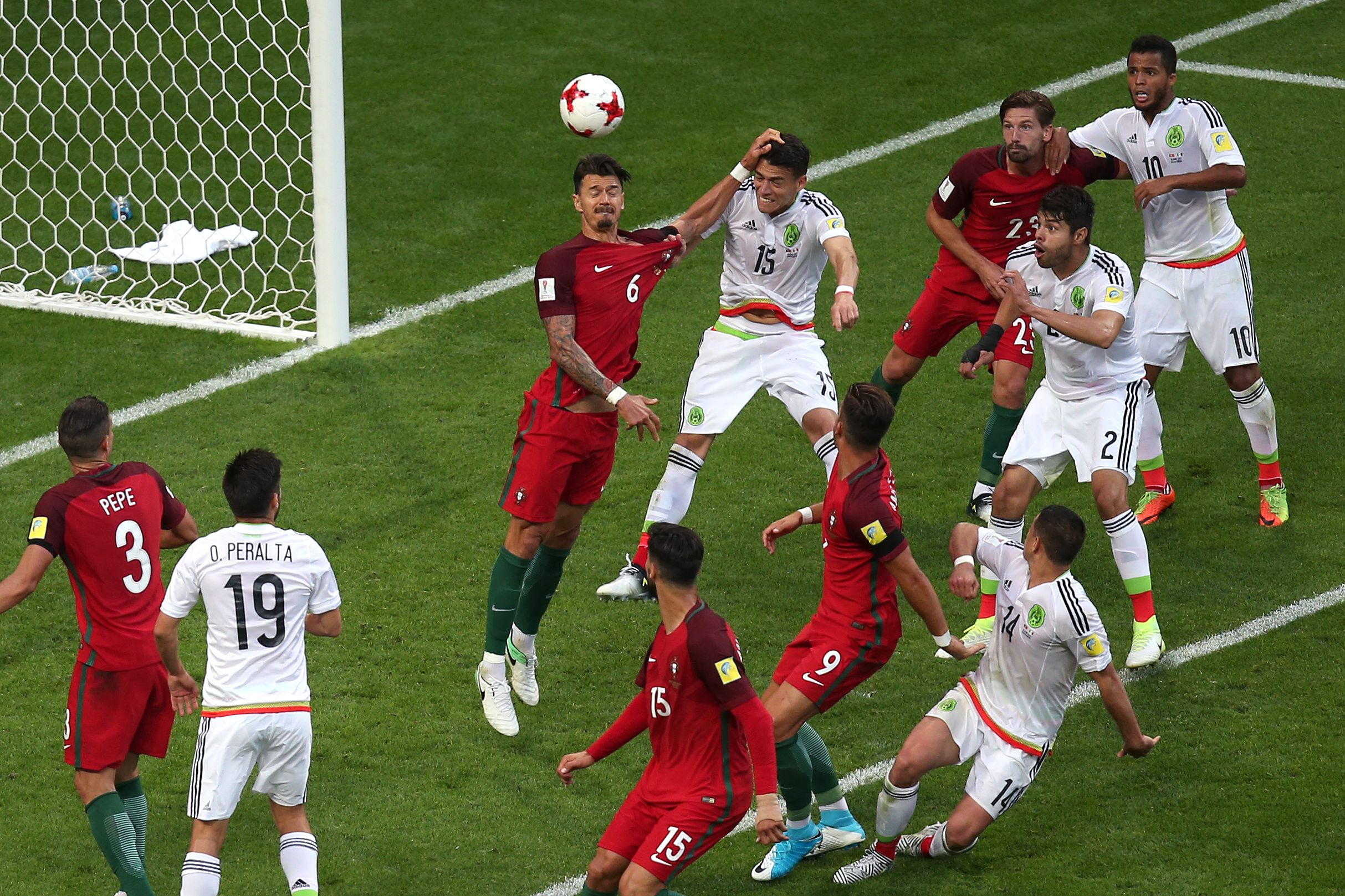 TOPSHOT - Mexico's defender Hector Moreno (C 15) heads the ball to score during the 2017 Confederations Cup group A football match between Portugal and Mexico at the Kazan Arena in Kazan on June 18, 2017. / AFP PHOTO / Roman Kruchinin (Photo credit should read ROMAN KRUCHININ/AFP/Getty Images)