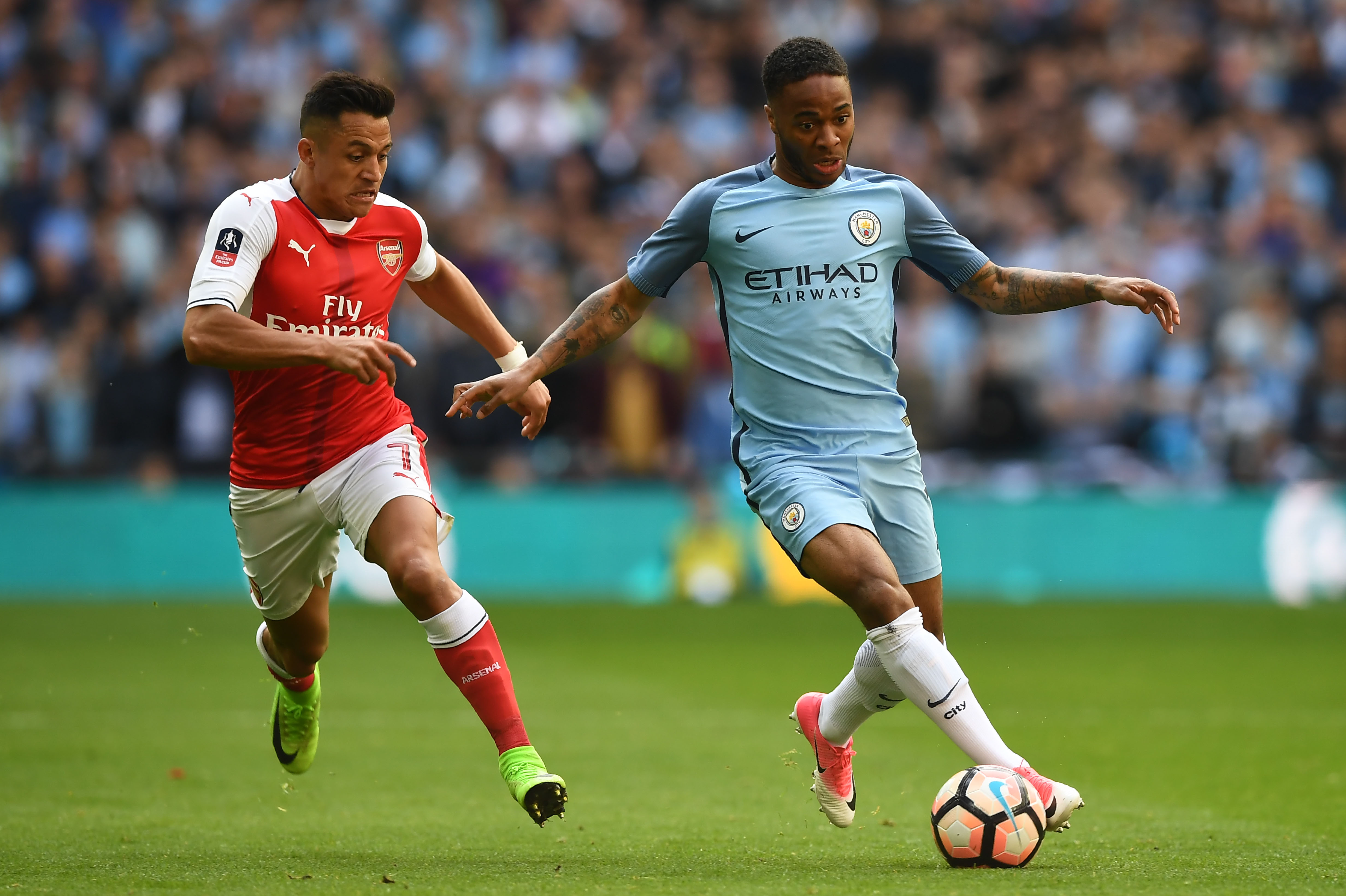 Arsenal's Chilean striker Alexis Sanchez (L) vies with Manchester City's English midfielder Raheem Sterling during the FA Cup semi-final football match between Arsenal and Manchester City at Wembley stadium in London on April 23, 2017. / AFP PHOTO / Justin TALLIS / NOT FOR MARKETING OR ADVERTISING USE / RESTRICTED TO EDITORIAL USE
(Photo credit should read JUSTIN TALLIS/AFP/Getty Images)