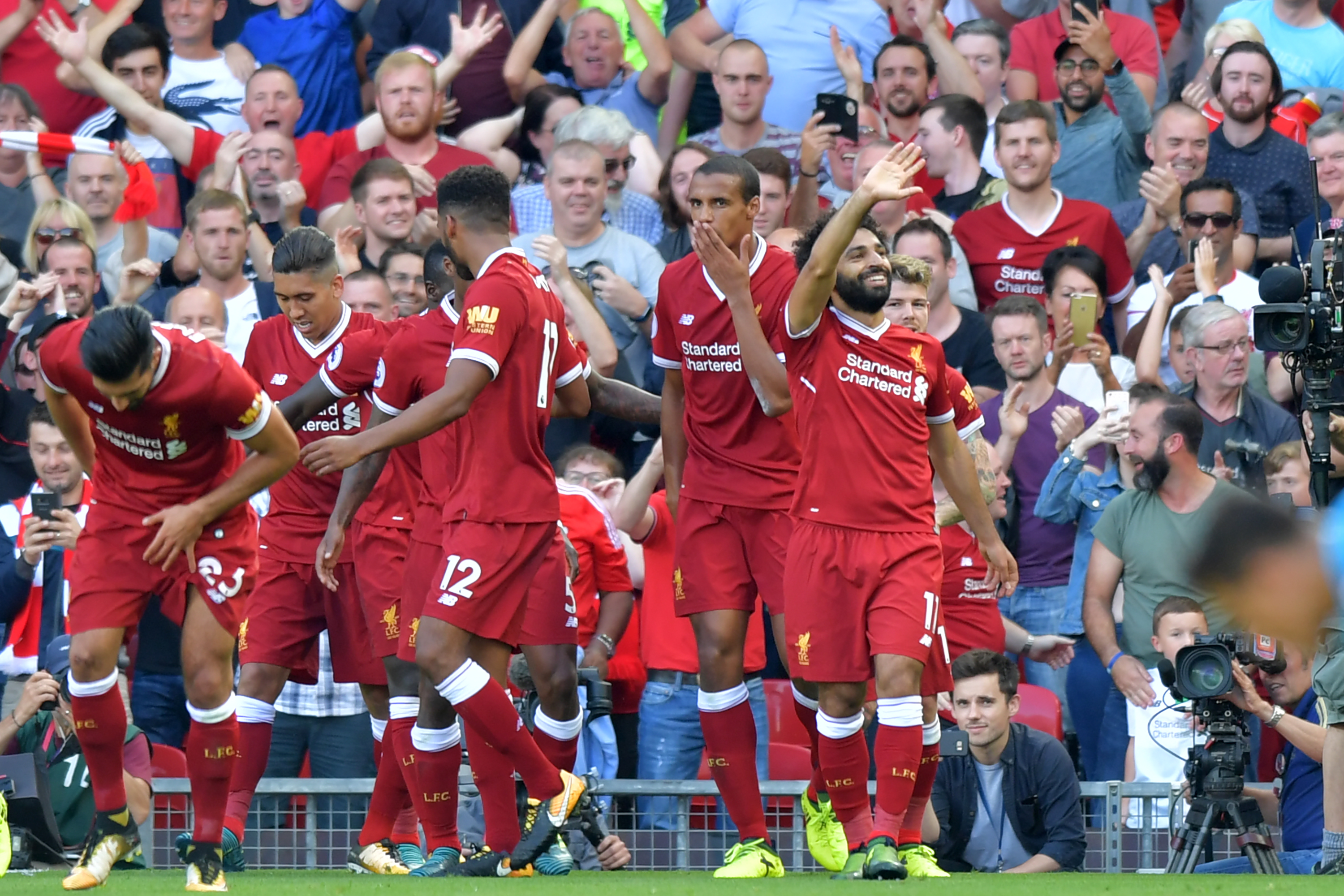 Liverpool's Egyptian midfielder Mohamed Salah (R) celebrates with teammates after scoring their third goal during the English Premier League football match between Liverpool and Arsenal at Anfield in Liverpool, north west England on August 27, 2017. / AFP PHOTO / Anthony Devlin / RESTRICTED TO EDITORIAL USE. No use with unauthorized audio, video, data, fixture lists, club/league logos or 'live' services. Online in-match use limited to 75 images, no video emulation. No use in betting, games or single club/league/player publications.  /         (Photo credit should read ANTHONY DEVLIN/AFP/Getty Images)