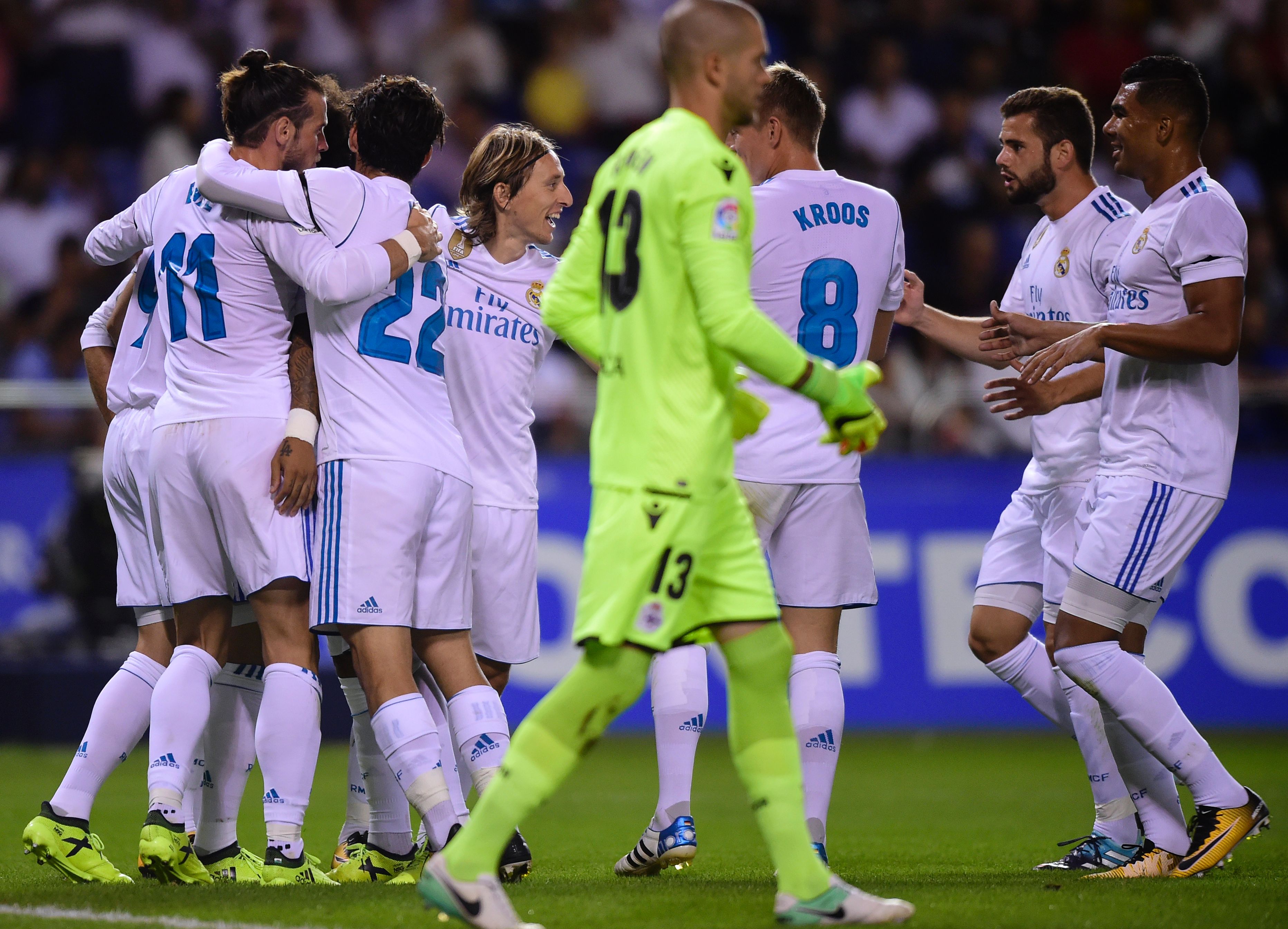 Real Madrid's Welsh forward Gareth Bale (L) celebrates with teammates after scoring during the Spanish league footbal match RC Deportivo de la Coruna vs Real Madrid CF at the Municipal de Riazor stadium in La Coruna on August 20, 2017.
Real Madrid won 3-0. / AFP PHOTO / MIGUEL RIOPA (Photo credit should read MIGUEL RIOPA/AFP/Getty Images)
