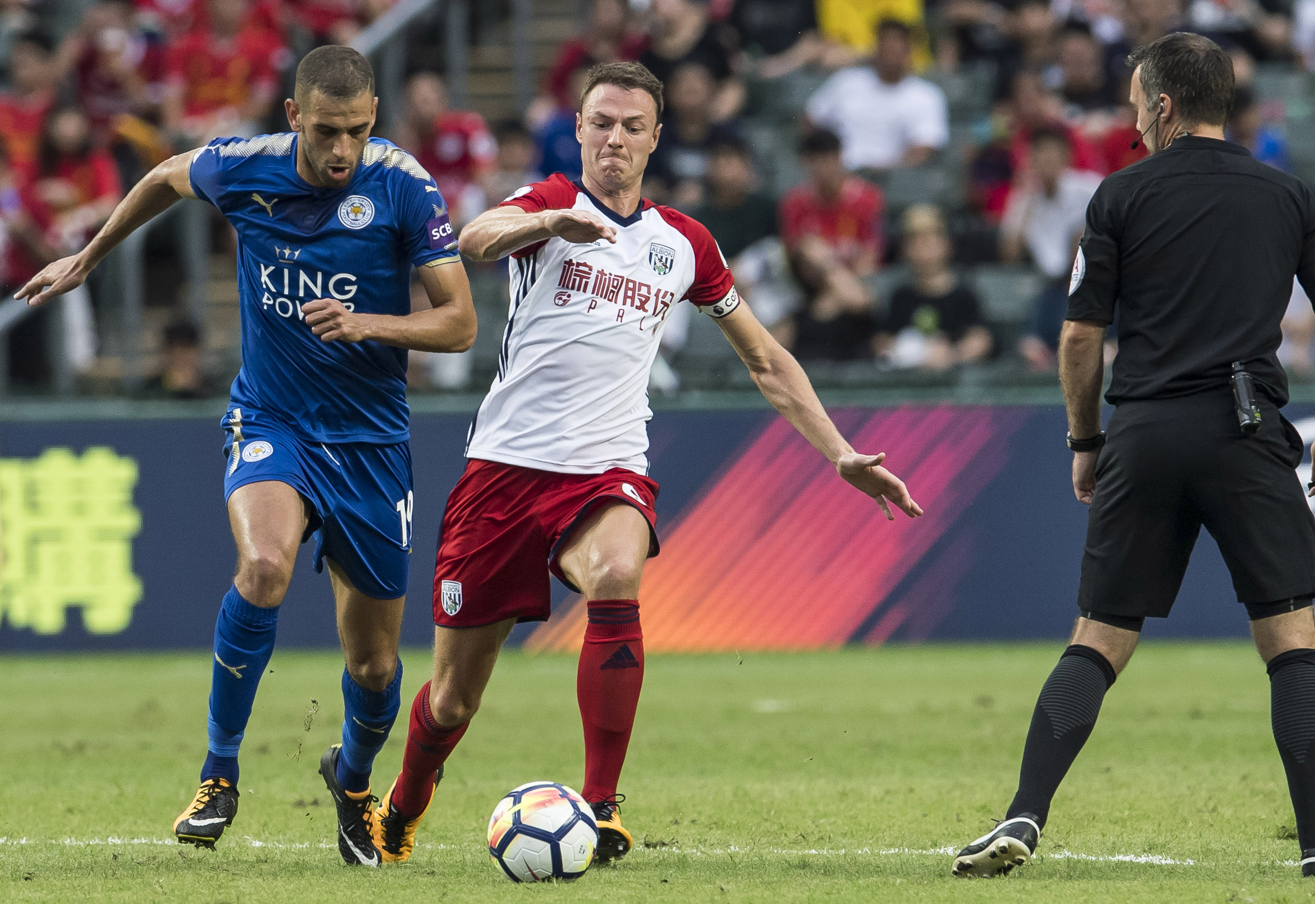 HONG KONG, HONG KONG - JULY 19: Leicester City FC forward Islam Slimani (L) fights for the ball with West Bromwich Albion defender Jonny Evans (R) during the Premier League Asia Trophy match between Leicester City FC and West Bromwich Albion at Hong Kong Stadium on July 19, 2017 in Hong Kong, Hong Kong. (Photo by Victor Fraile/Getty Images)
