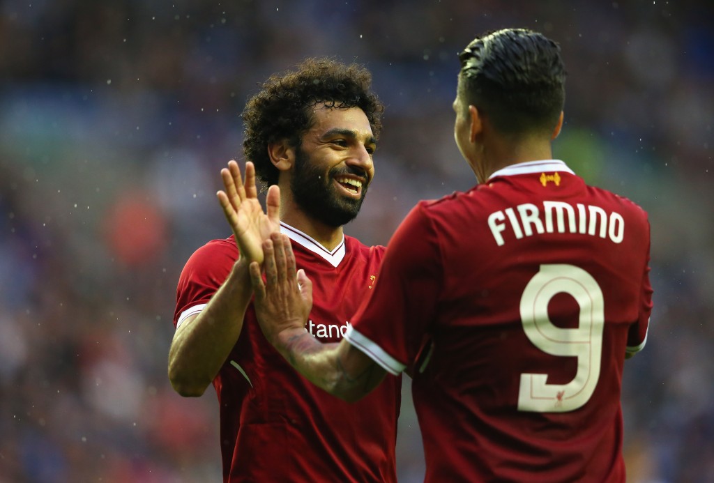 WIGAN, ENGLAND - JULY 14: Mohamed Salah of Liverpool celebrates with Roberto Firmino after scoring their first goal during the pre-season friendly match between Wigan Athletic and Liverpool at DW Stadium on July 14, 2017 in Wigan, England. (Photo by Alex Livesey/Getty Images)