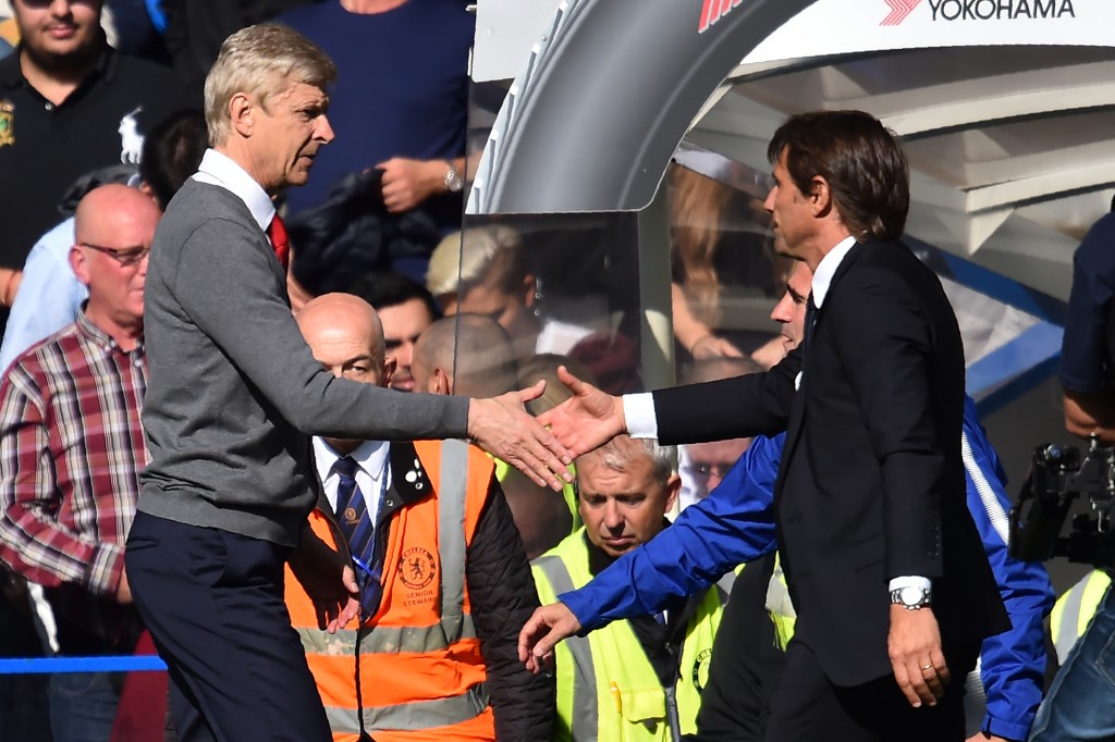 Chelsea's Italian head coach Antonio Conte (R) shakes hands with Arsenal's French manager Arsene Wenger (L) after the English Premier League football match between Chelsea and Arsenal at Stamford Bridge in London on September 17, 2017. The game ended 0-0. / AFP PHOTO / Glyn KIRK / RESTRICTED TO EDITORIAL USE. No use with unauthorized audio, video, data, fixture lists, club/league logos or 'live' services. Online in-match use limited to 75 images, no video emulation. No use in betting, games or single club/league/player publications. / (Photo credit should read GLYN KIRK/AFP/Getty Images)