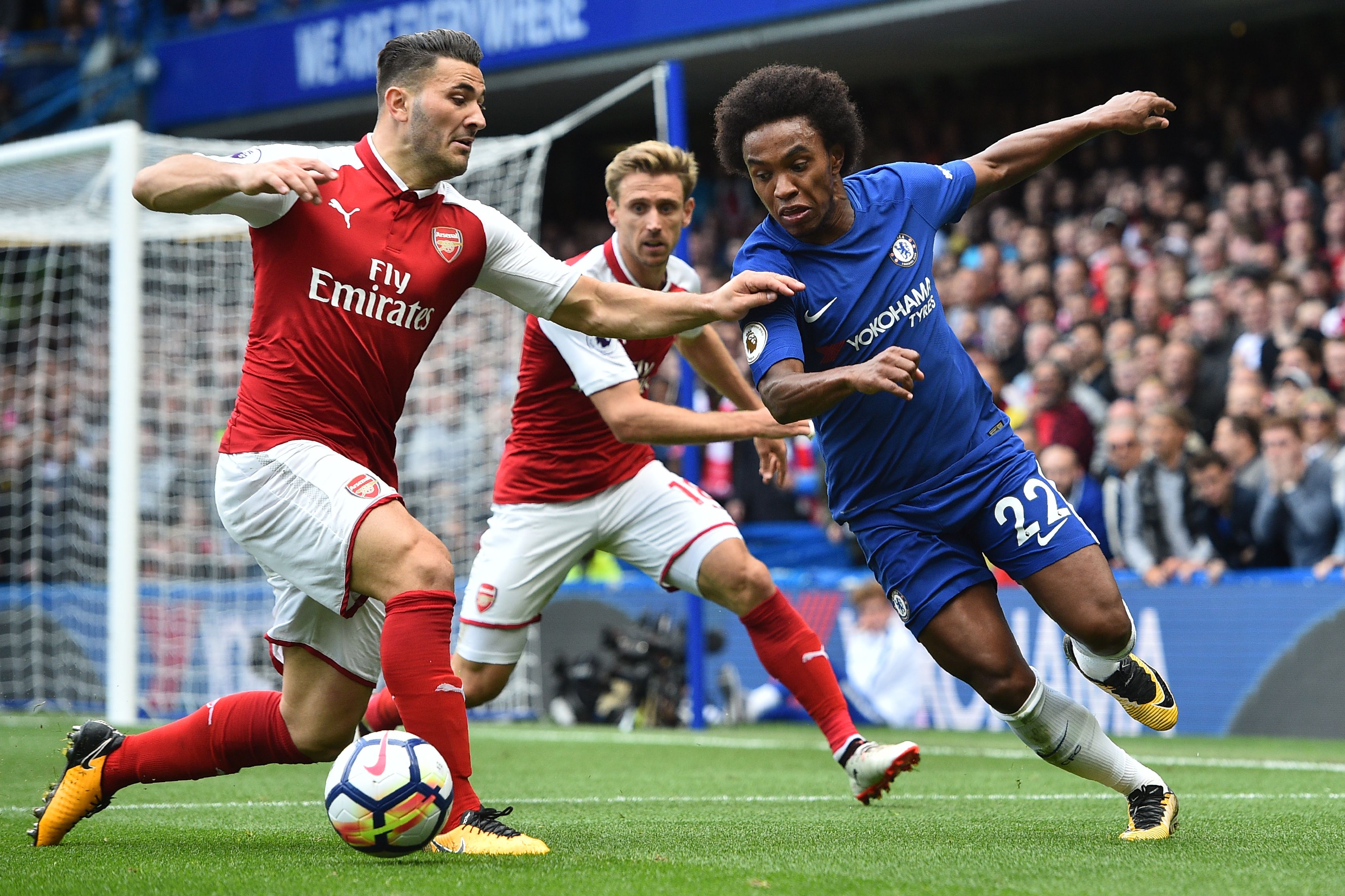 Arsenal's German-born Bosnian defender Sead Kolasinac (L) vies with Chelsea's Brazilian midfielder Willian during the English Premier League football match between Chelsea and Arsenal at Stamford Bridge in London on September 17, 2017. / AFP PHOTO / Glyn KIRK / RESTRICTED TO EDITORIAL USE. No use with unauthorized audio, video, data, fixture lists, club/league logos or 'live' services. Online in-match use limited to 75 images, no video emulation. No use in betting, games or single club/league/player publications. / (Photo credit should read GLYN KIRK/AFP/Getty Images)