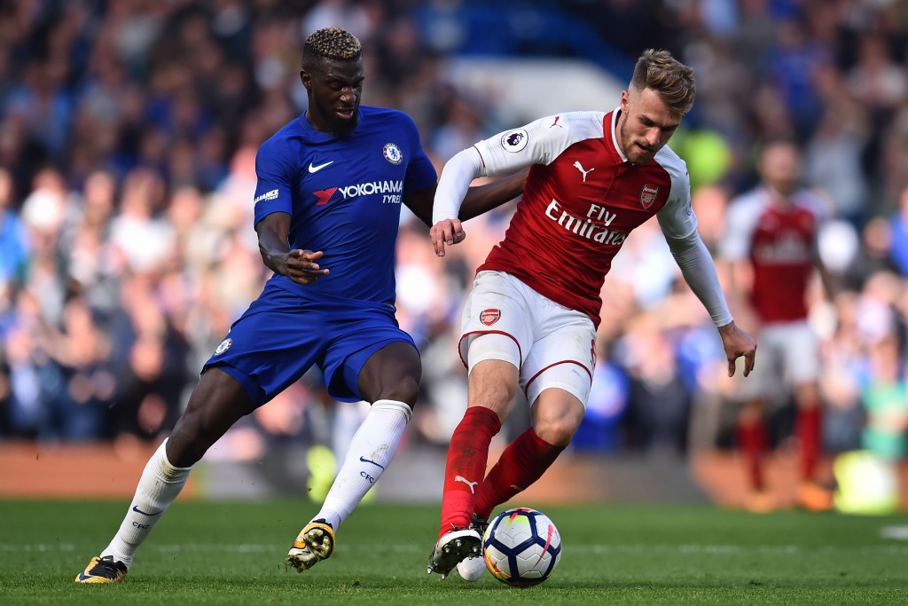 Arsenal's Welsh midfielder Aaron Ramsey (R) vies with Chelsea's French midfielder Tiemoue Bakayoko during the English Premier League football match between Chelsea and Arsenal at Stamford Bridge in London on September 17, 2017. / AFP PHOTO / Glyn KIRK / RESTRICTED TO EDITORIAL USE. No use with unauthorized audio, video, data, fixture lists, club/league logos or 'live' services. Online in-match use limited to 75 images, no video emulation. No use in betting, games or single club/league/player publications. / (Photo credit should read GLYN KIRK/AFP/Getty Images)