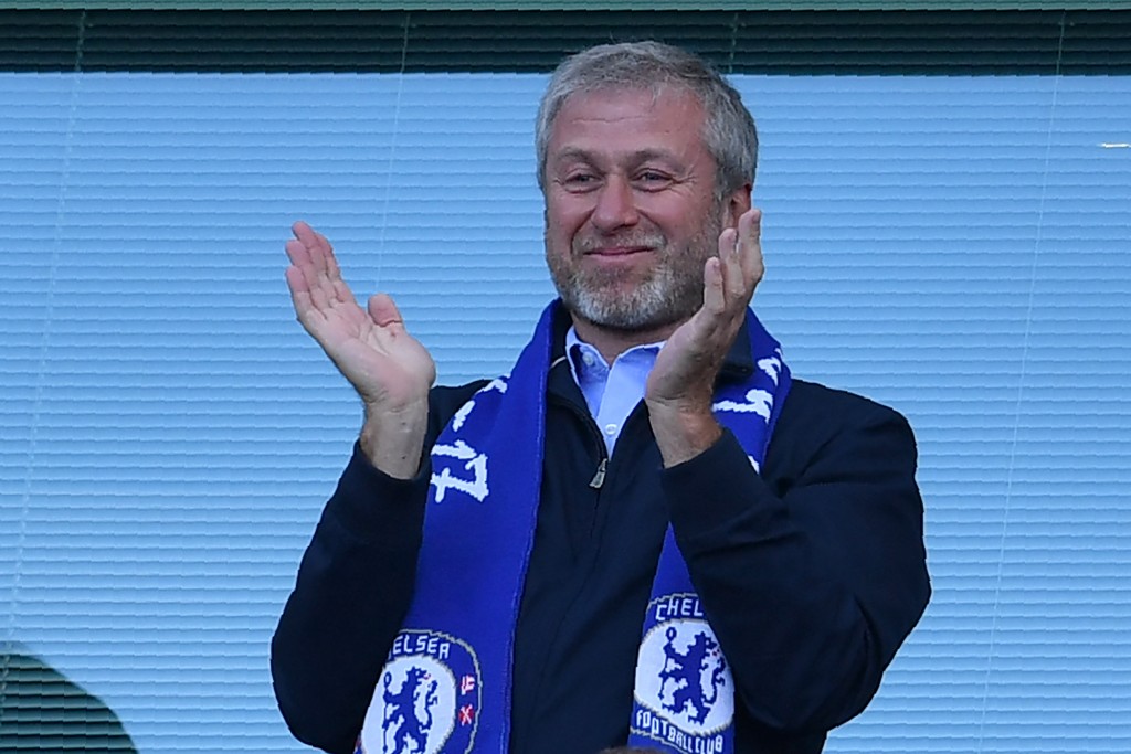 Chelsea's Russian owner Roman Abramovich applauds, as players celebrate their league title win at the end of the Premier League football match between Chelsea and Sunderland at Stamford Bridge in London on May 21, 2017. Chelsea's extended victory parade reached a climax with the trophy presentation on May 21, 2017 after being crowned Premier League champions with two games to go. / AFP PHOTO / Ben STANSALL / RESTRICTED TO EDITORIAL USE. No use with unauthorized audio, video, data, fixture lists, club/league logos or 'live' services. Online in-match use limited to 75 images, no video emulation. No use in betting, games or single club/league/player publications. / (Photo credit should read BEN STANSALL/AFP/Getty Images)