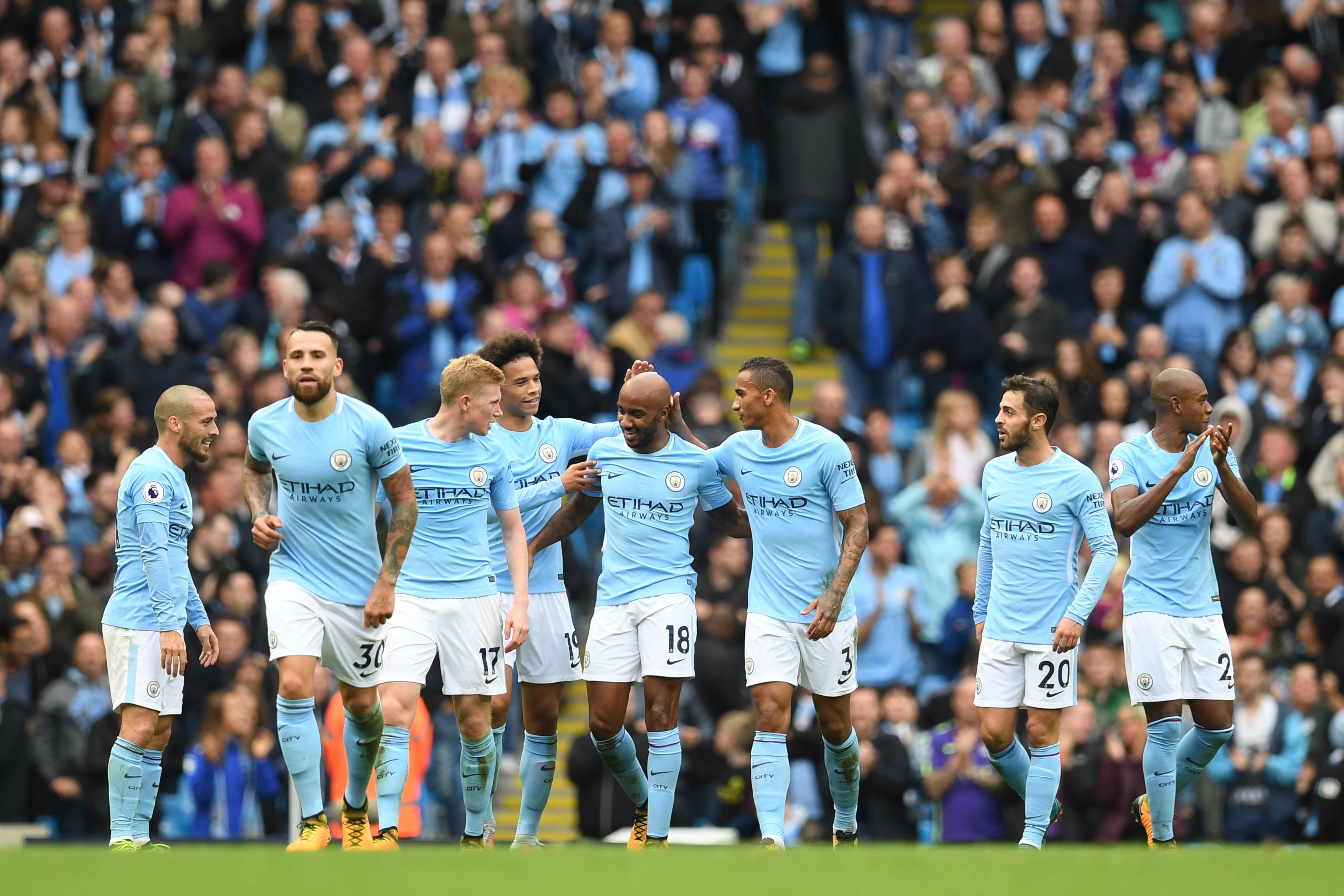 Manchester City's English midfielder Fabian Delph (C) celebrates with teammates after scoring their fifth goal during the English Premier League football match between Manchester City and Crystal Palace at the Etihad Stadium in Manchester, north west England, on September 23, 2017. / AFP PHOTO / Paul ELLIS / RESTRICTED TO EDITORIAL USE. No use with unauthorized audio, video, data, fixture lists, club/league logos or 'live' services. Online in-match use limited to 75 images, no video emulation. No use in betting, games or single club/league/player publications. / (Photo credit should read PAUL ELLIS/AFP/Getty Images)