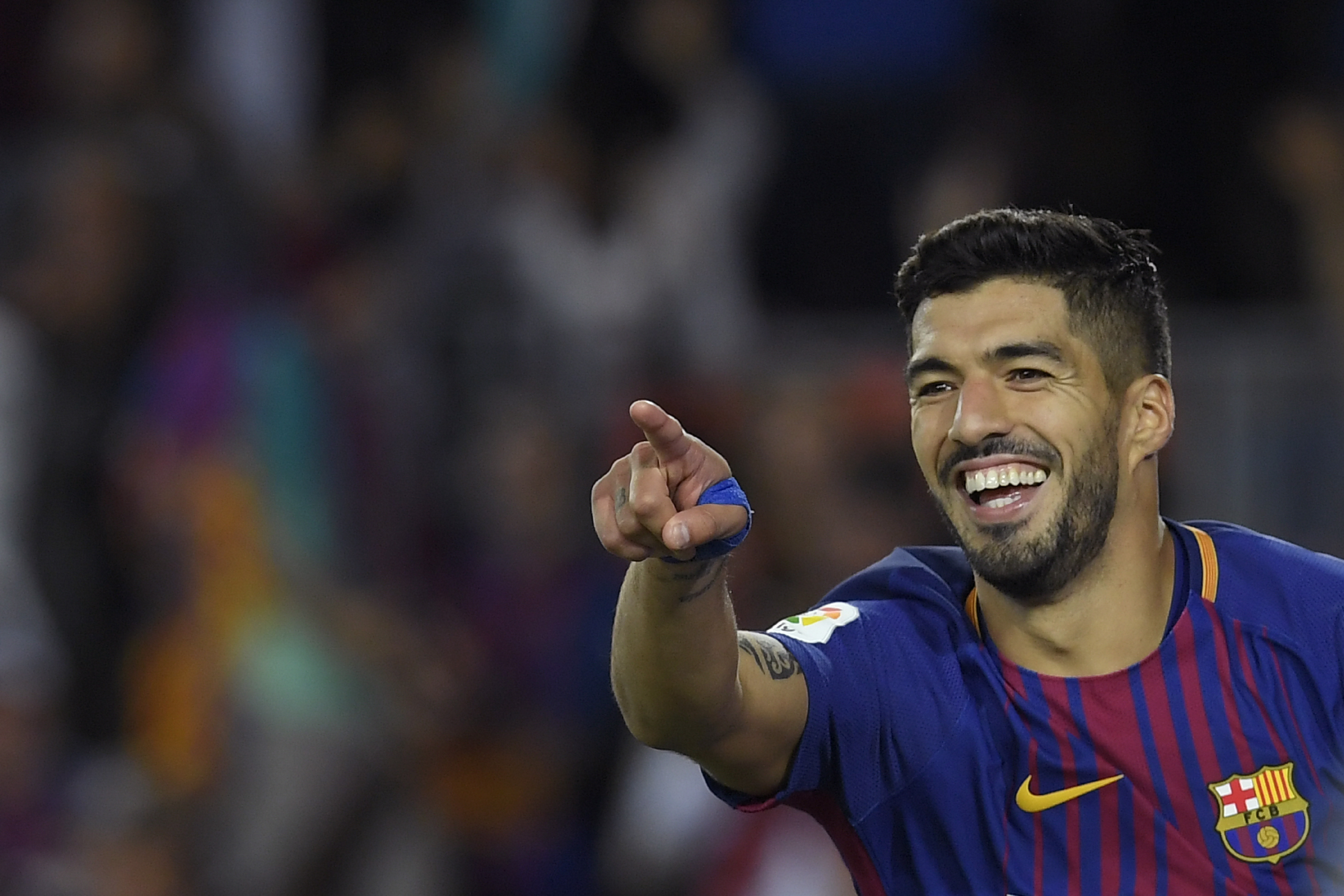 Barcelona's Uruguayan forward Luis Suarez celebrates after scoring during the Spanish Liga football match Barcelona vs Espanyol at the Camp Nou stadium in Barcelona on September 9, 2017. / AFP PHOTO / LLUIS GENE        (Photo credit should read LLUIS GENE/AFP/Getty Images)