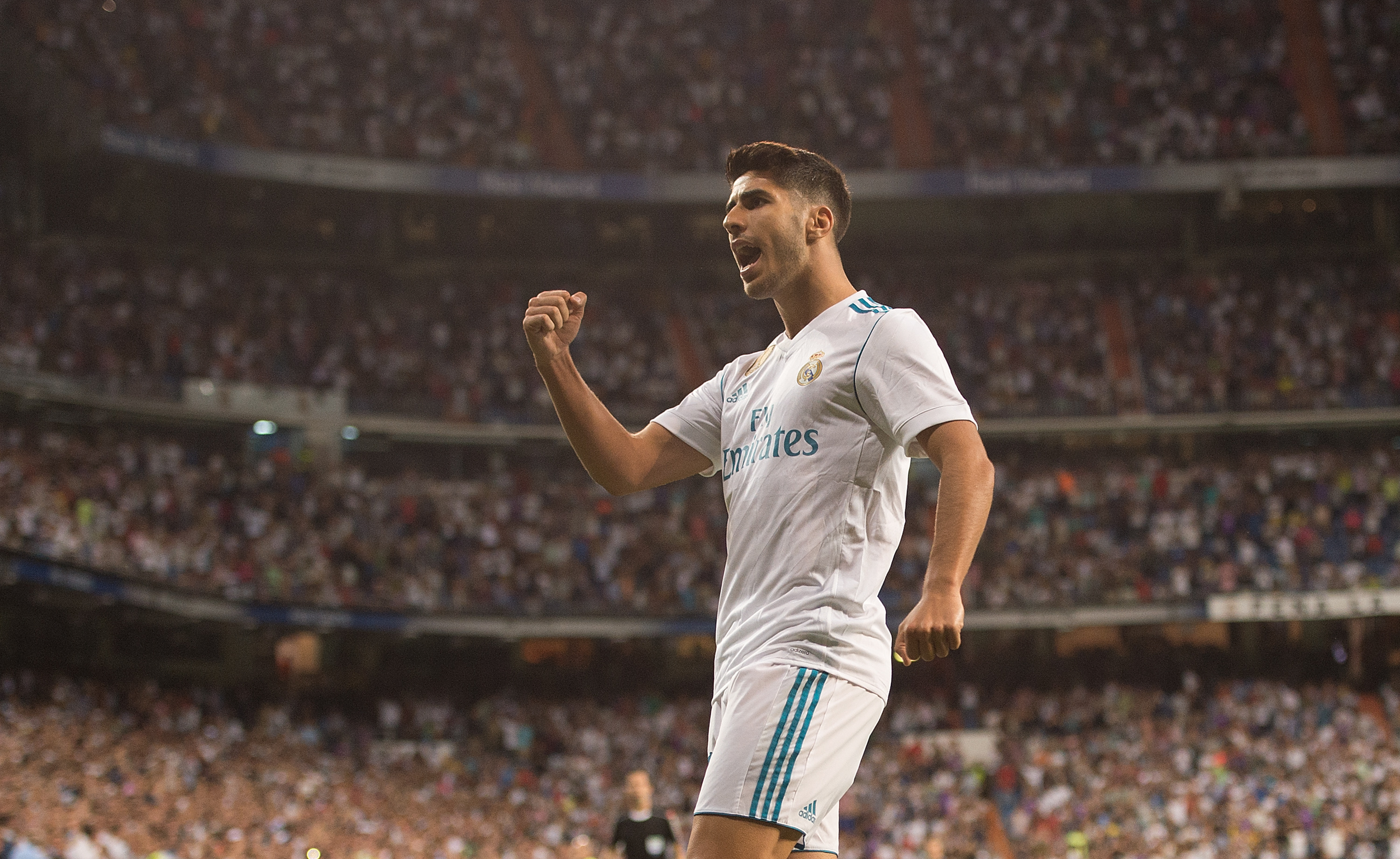 MADRID, SPAIN - AUGUST 27: Marco Asensio of Real Madrid CF celebrates after scoring his teamÕs 1st goal during the La Liga match between Real Madrid CF and Valencia CF at Estadio Santiago Bernabeu on August 27, 2017 in Madrid, Spain . (Photo by Denis Doyle/Getty Images)