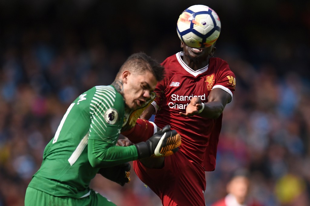 TOPSHOT - Liverpool's Senegalese midfielder Sadio Mane (R) challenges Manchester City's Brazilian goalkeeper Ederson (L), a challenge for which he is sent off, during the English Premier League football match between Manchester City and Liverpool at the Etihad Stadium in Manchester, north west England, on September 9, 2017. / AFP PHOTO / Oli SCARFF / RESTRICTED TO EDITORIAL USE. No use with unauthorized audio, video, data, fixture lists, club/league logos or 'live' services. Online in-match use limited to 75 images, no video emulation. No use in betting, games or single club/league/player publications. / (Photo credit should read OLI SCARFF/AFP/Getty Images)