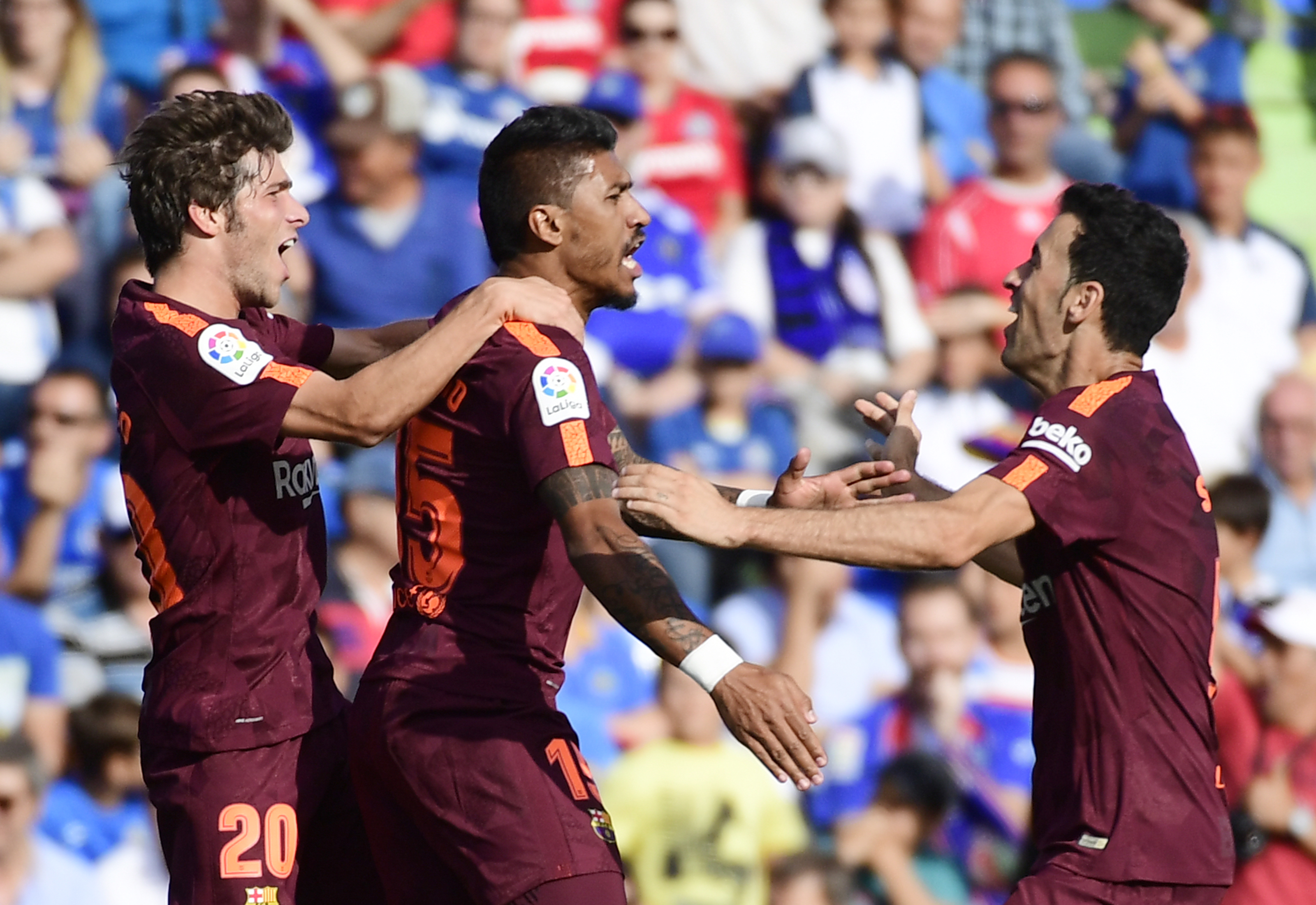Barcelona's midfielder from Brazil Paulinho (C) celebrates a goal with Barcelona's midfielder from Spain Sergi Roberto (L) and Barcelona's midfielder from Spain Sergio Busquets during the Spanish league football match Getafe CF vs FC Barcelona at the Col. Alfonso Perez stadium in Getafe on September 16, 2017. / AFP PHOTO / PIERRE-PHILIPPE MARCOU (Photo credit should read PIERRE-PHILIPPE MARCOU/AFP/Getty Images)