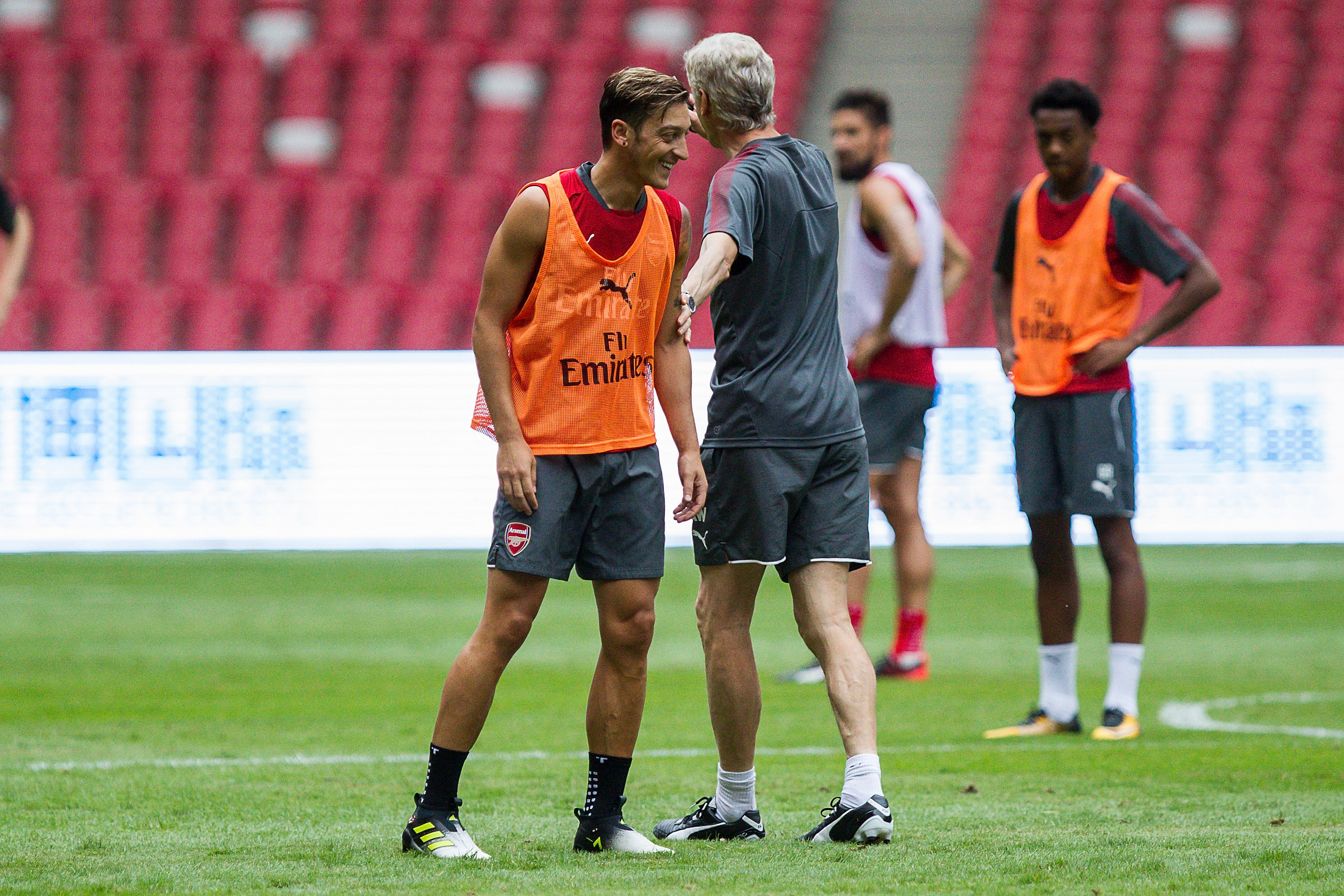 BEIJING, CHINA - JULY 21:  Mesut Ozil  and Arsene Wenger talk during a training session at Birds Nest on July 21, 2017 in Beijing, China.  (Photo by Yifan Ding/Getty Images)