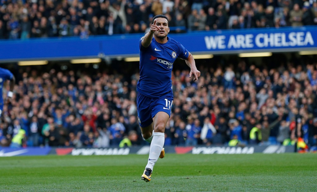 Chelsea's Spanish midfielder Pedro celebrates scoring the opening goal during the English Premier League football match between Chelsea and Watford at Stamford Bridge in London on October 21, 2017. / AFP PHOTO / Ian KINGTON / RESTRICTED TO EDITORIAL USE. No use with unauthorized audio, video, data, fixture lists, club/league logos or 'live' services. Online in-match use limited to 75 images, no video emulation. No use in betting, games or single club/league/player publications. / (Photo credit should read IAN KINGTON/AFP/Getty Images)