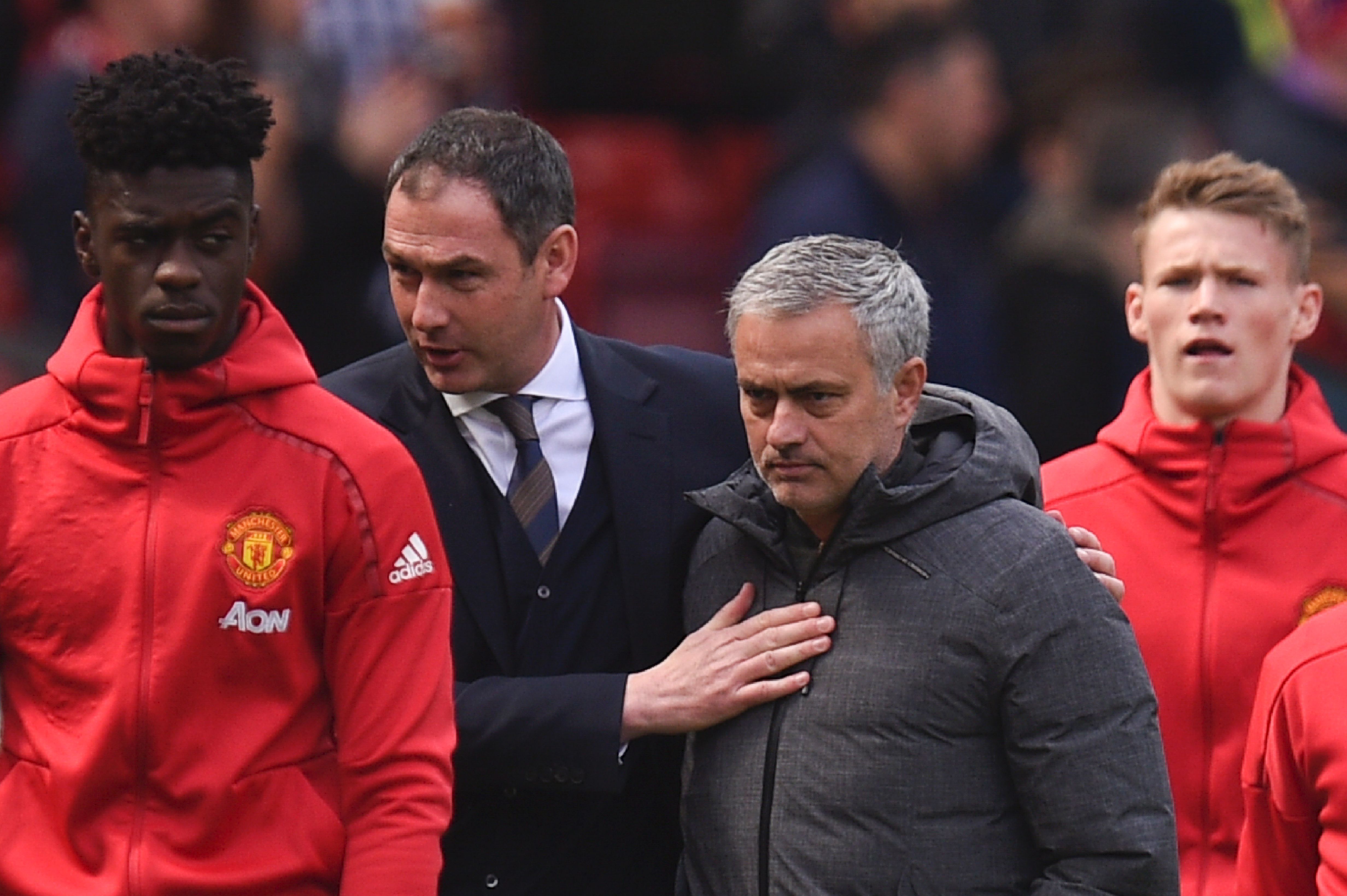 Manchester United's Portuguese manager Jose Mourinho (2R) and Swansea City's English head coach Paul Clement (2L) arrive on the field for the English Premier League football match between Manchester United and Swansea City at Old Trafford in Manchester, north west England, on April 30, 2017. / AFP PHOTO / Oli SCARFF / RESTRICTED TO EDITORIAL USE. No use with unauthorized audio, video, data, fixture lists, club/league logos or 'live' services. Online in-match use limited to 75 images, no video emulation. No use in betting, games or single club/league/player publications. / (Photo credit should read OLI SCARFF/AFP/Getty Images)