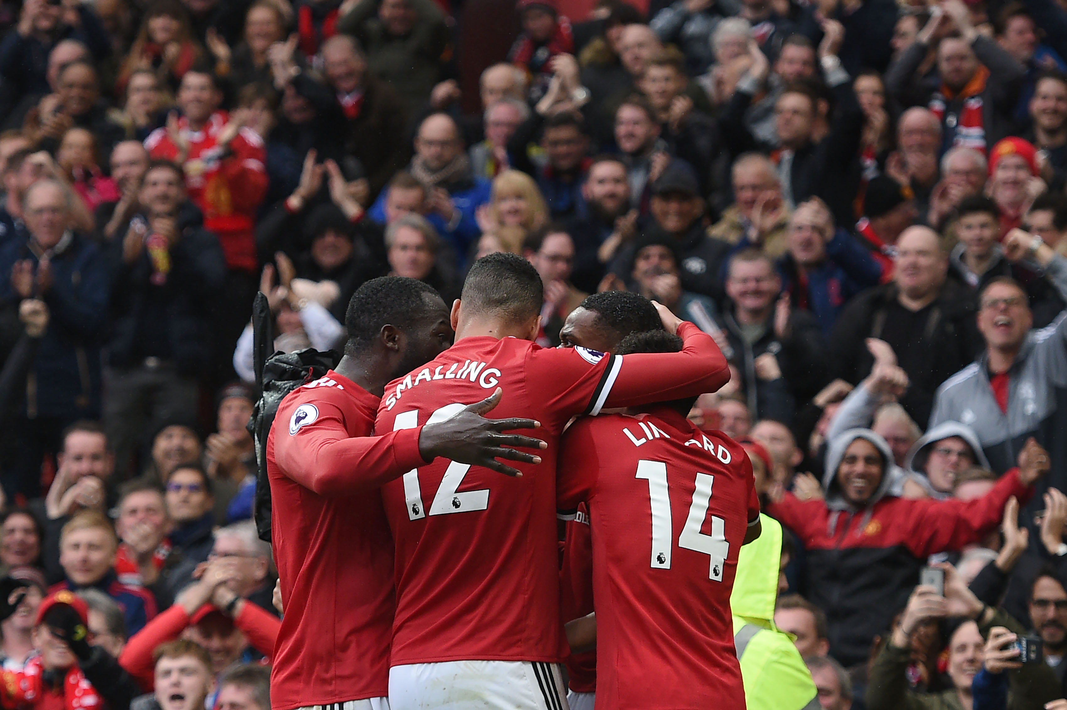 Manchester United's French striker Anthony Martial (2nd R) celebrates with teammates after scoring the opening goal of the English Premier League football match between Manchester United and Tottenham Hotspur at Old Trafford in Manchester, north west England, on October 28, 2017.
Manchester United won the game 1-0. / AFP PHOTO / Oli SCARFF / RESTRICTED TO EDITORIAL USE. No use with unauthorized audio, video, data, fixture lists, club/league logos or 'live' services. Online in-match use limited to 75 images, no video emulation. No use in betting, games or single club/league/player publications. / (Photo credit should read OLI SCARFF/AFP/Getty Images)