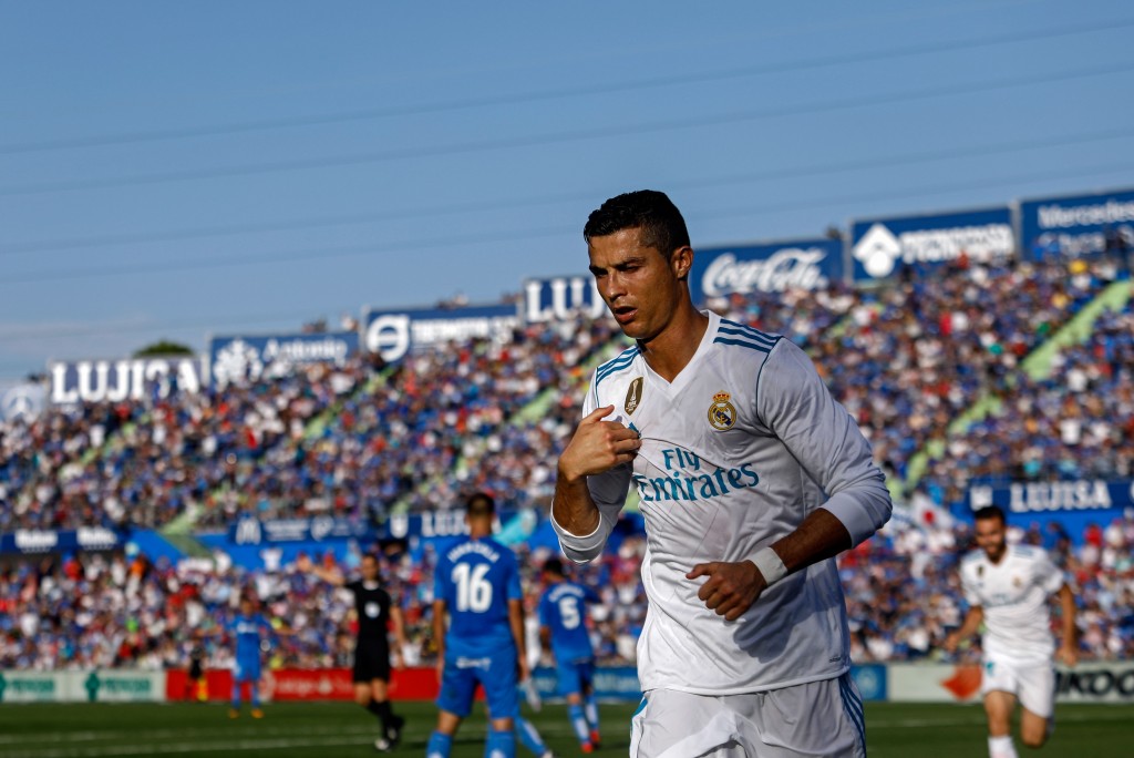 Real Madrid's Portuguese forward Cristiano Ronaldo crosses himself to celebrate his team's second goal during the Spanish league football match Getafe CF vs Real Madrid CF at the Col. Alfonso Perez stadium in Getafe on October 14, 2017. / AFP PHOTO / OSCAR DEL POZO (Photo credit should read OSCAR DEL POZO/AFP/Getty Images)
