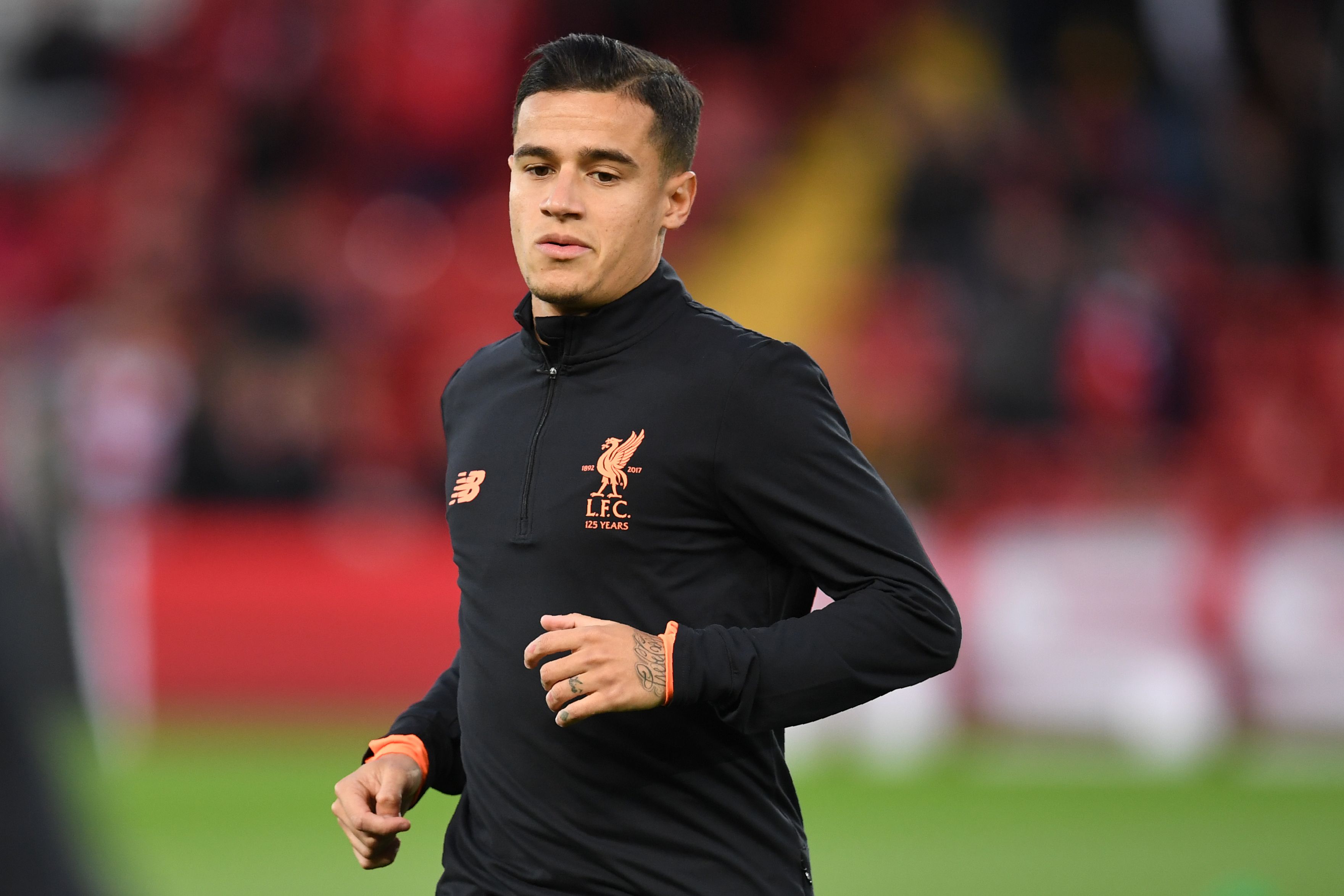 Liverpool's Brazilian midfielder Philippe Coutinho warms up before the UEFA Champions League Group E football match between Liverpool and Sevilla at Anfield in Liverpool, north-west England on September 13, 2017. / AFP PHOTO / Paul ELLIS        (Photo credit should read PAUL ELLIS/AFP/Getty Images)
