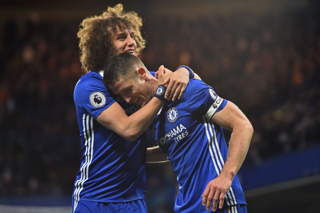 Chelsea's English defender Gary Cahill celebrates with Chelsea's Brazilian defender David Luiz (L) after scoring their second goal during the English Premier League football match between Chelsea and Southampton at Stamford Bridge in London on April 25, 2017. / AFP PHOTO / Glyn KIRK / RESTRICTED TO EDITORIAL USE. No use with unauthorized audio, video, data, fixture lists, club/league logos or 'live' services. Online in-match use limited to 75 images, no video emulation. No use in betting, games or single club/league/player publications. / (Photo credit should read GLYN KIRK/AFP/Getty Images)