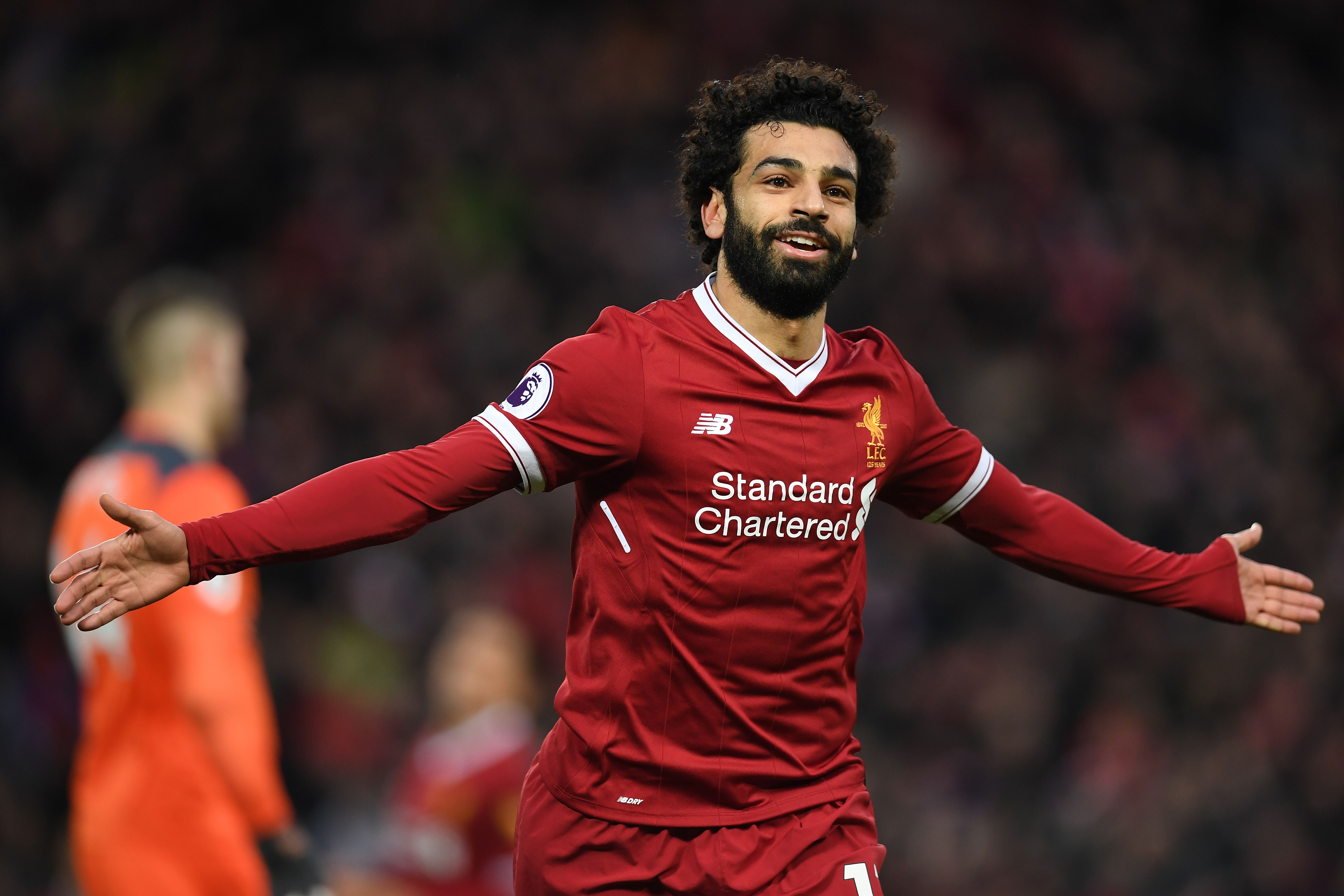 Liverpool's Egyptian midfielder Mohamed Salah celebrates scoring his team's second goal during the English Premier League football match between Liverpool and Southampton at Anfield in Liverpool, north west England on November 18, 2017. / AFP PHOTO / Paul ELLIS / RESTRICTED TO EDITORIAL USE. No use with unauthorized audio, video, data, fixture lists, club/league logos or 'live' services. Online in-match use limited to 75 images, no video emulation. No use in betting, games or single club/league/player publications. / (Photo credit should read PAUL ELLIS/AFP/Getty Images)