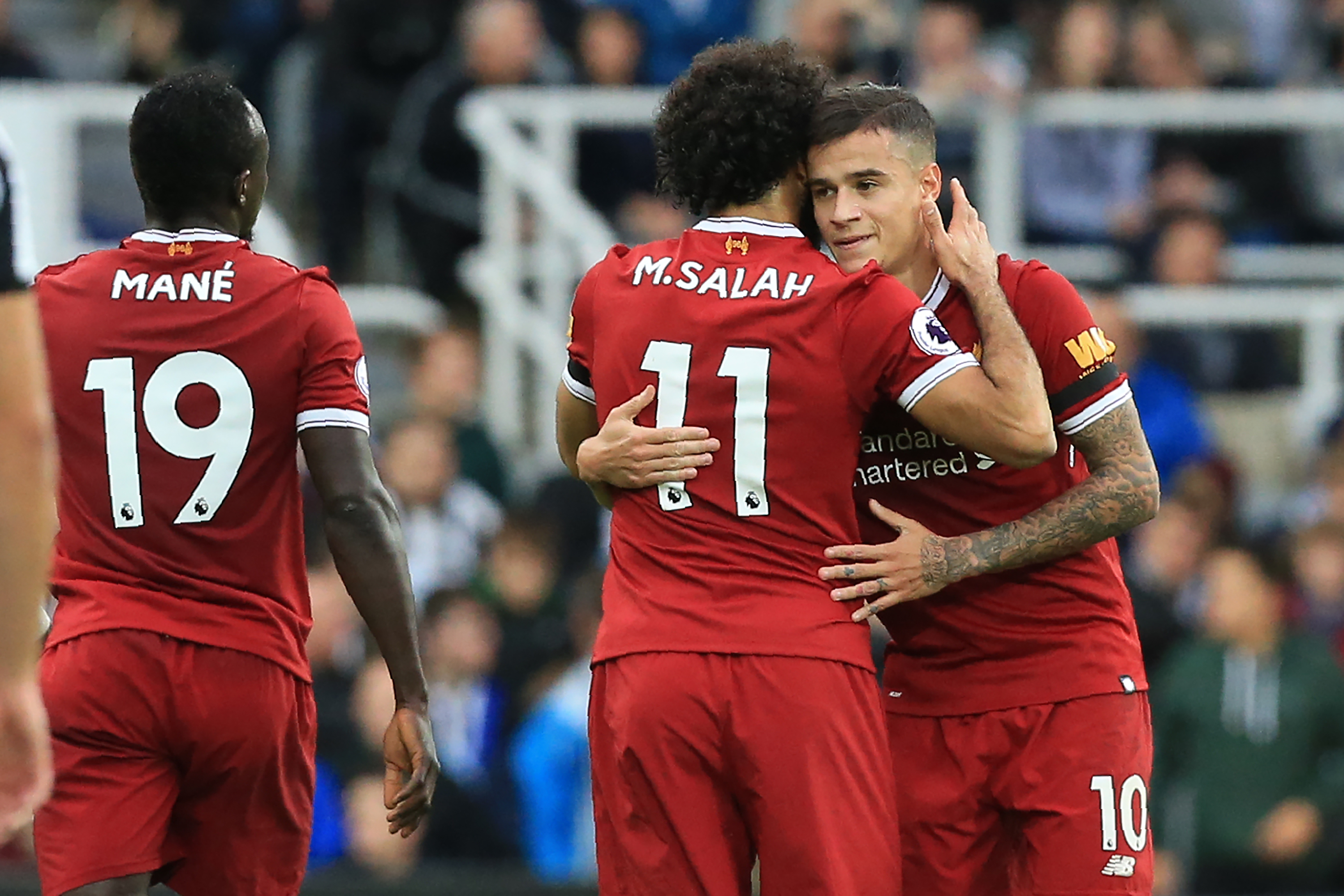 Liverpool's Brazilian midfielder Philippe Coutinho (R) celebrates with Liverpool's Egyptian midfielder Mohamed Salah after scoring the opening goal of the English Premier League football match between Newcastle United and Liverpool at St James' Park in Newcastle-upon-Tyne, north east England on October 1, 2017. / AFP PHOTO / Lindsey PARNABY / RESTRICTED TO EDITORIAL USE. No use with unauthorized audio, video, data, fixture lists, club/league logos or 'live' services. Online in-match use limited to 75 images, no video emulation. No use in betting, games or single club/league/player publications. / (Photo credit should read LINDSEY PARNABY/AFP/Getty Images)