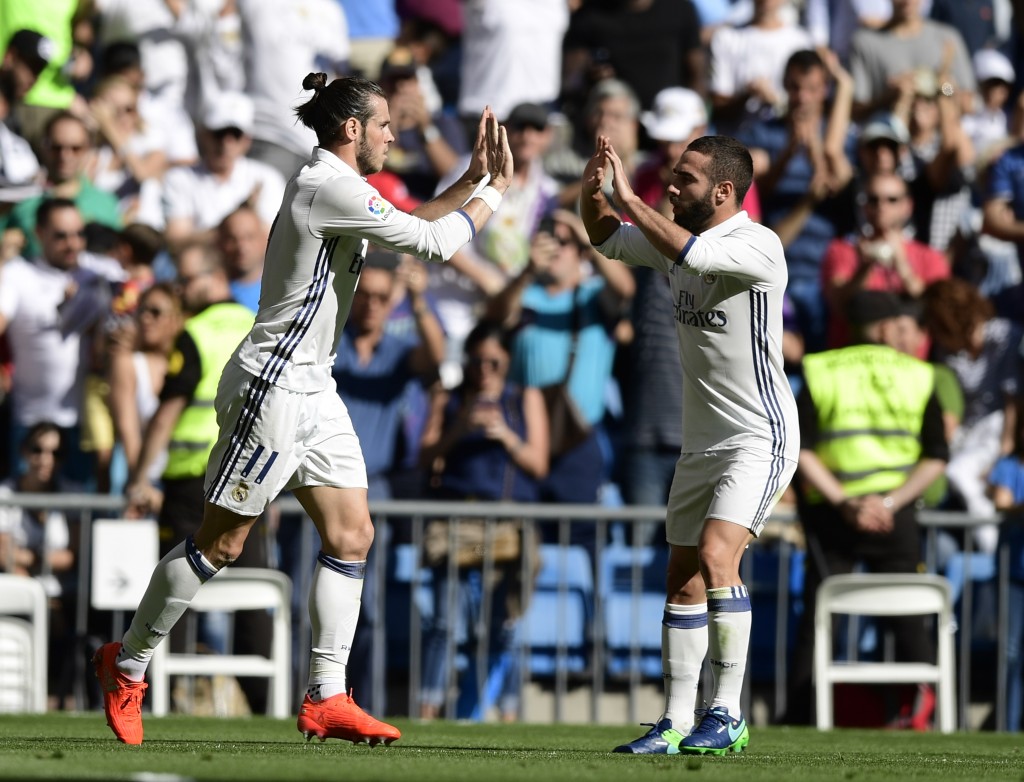 Real Madrid's Welsh forward Gareth Bale (L) and Real Madrid's defender Dani Carvajal celebrate after scoring a goal during the Spanish league football match Real Madrid CF vs SD Eibar at the Santiago Bernabeu stadium in Madrid on October 2, 2016. / AFP / JAVIER SORIANO (Photo credit should read JAVIER SORIANO/AFP/Getty Images)