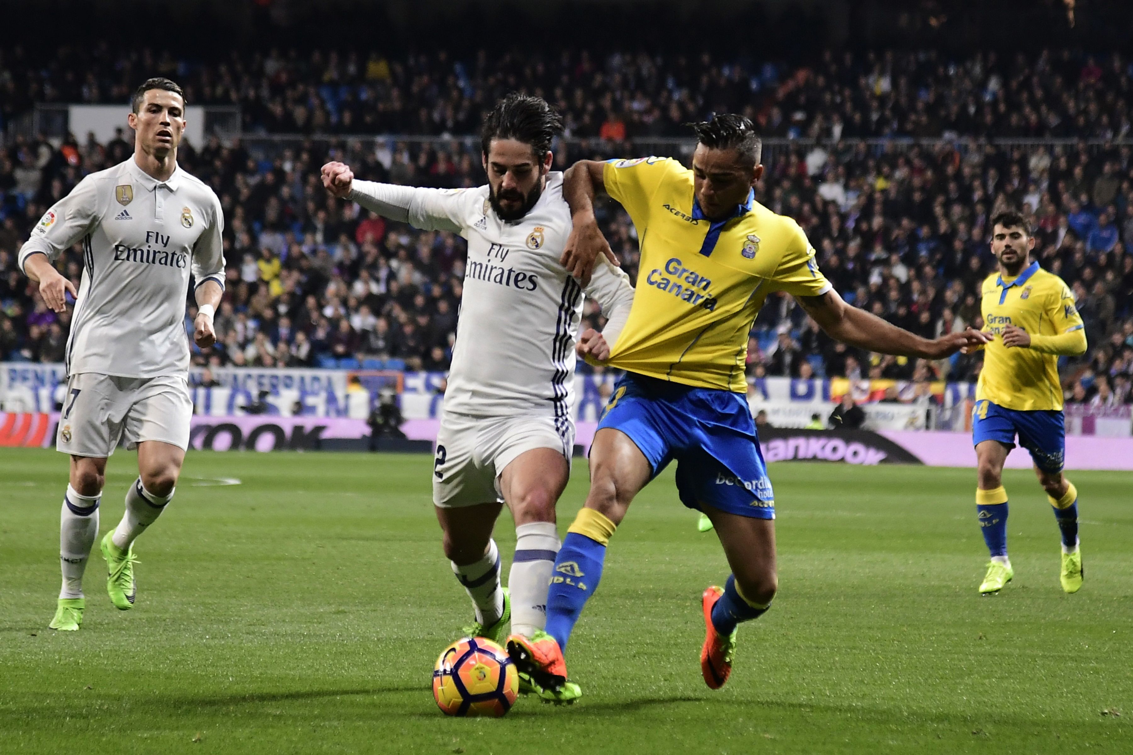 Real Madrid's midfielder Isco (2ndL) vies with Las Palmas' defender David Simon during the Spanish league football match Real Madrid CF vs UD Las Palmas at the Santiago Bernabeu stadium in Madrid on March 1, 2017. / AFP PHOTO / JAVIER SORIANO (Photo credit should read JAVIER SORIANO/AFP/Getty Images)
