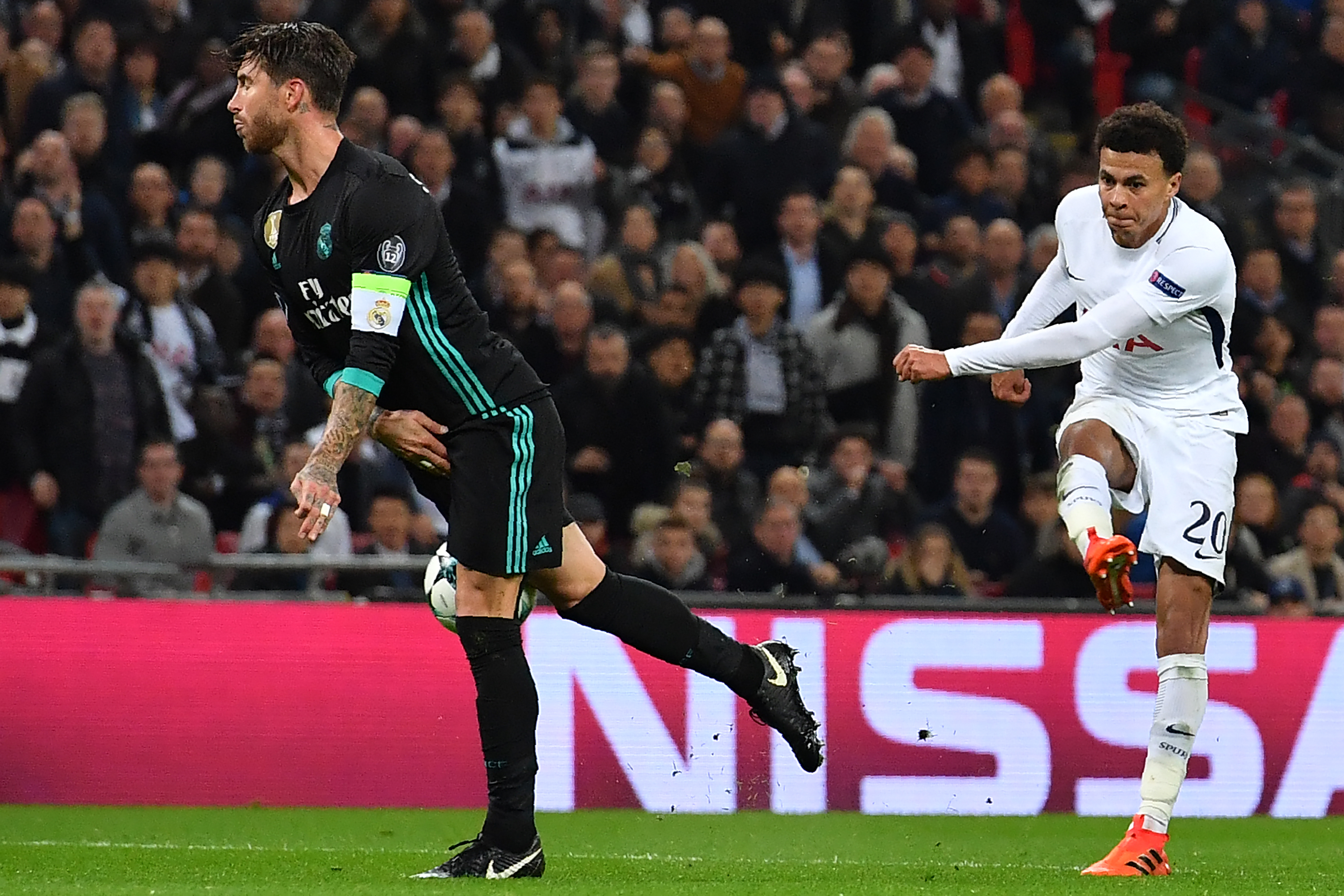 Tottenham Hotspur's English midfielder Dele Alli (R) has this shot deflected off Real Madrid's Spanish defender Sergio Ramos (L) for their second goal during the UEFA Champions League Group H football match between Tottenham Hotspur and Real Madrid at Wembley Stadium in London, on November 1, 2017. / AFP PHOTO / Ben STANSALL (Photo credit should read BEN STANSALL/AFP/Getty Images)