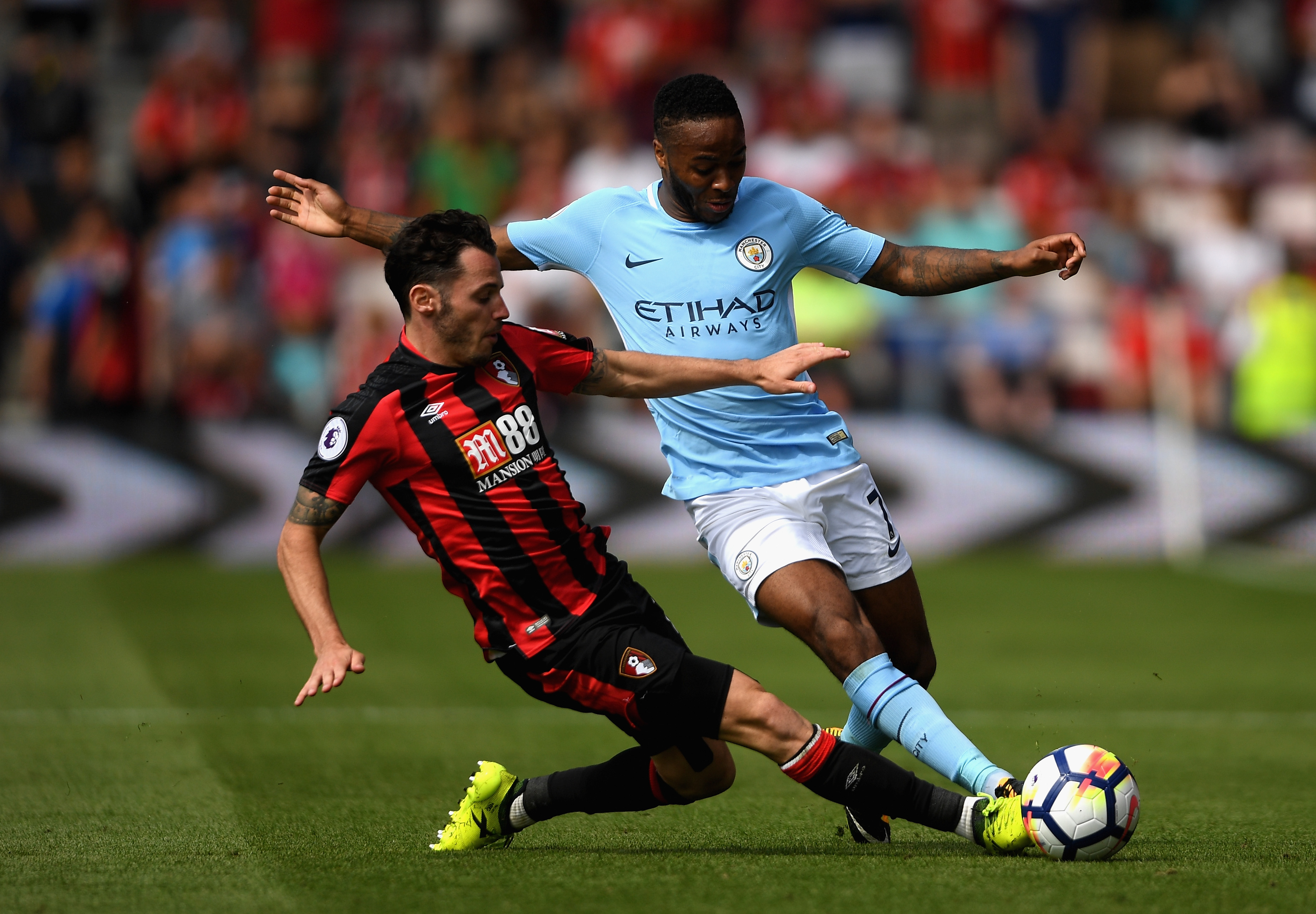BOURNEMOUTH, ENGLAND - AUGUST 26: Adam Smith of AFC Bournemouth and Raheem Sterling of Manchester City battle for possession during the Premier League match between AFC Bournemouth and Manchester City at Vitality Stadium on August 26, 2017 in Bournemouth, England. (Photo by Mike Hewitt/Getty Images)