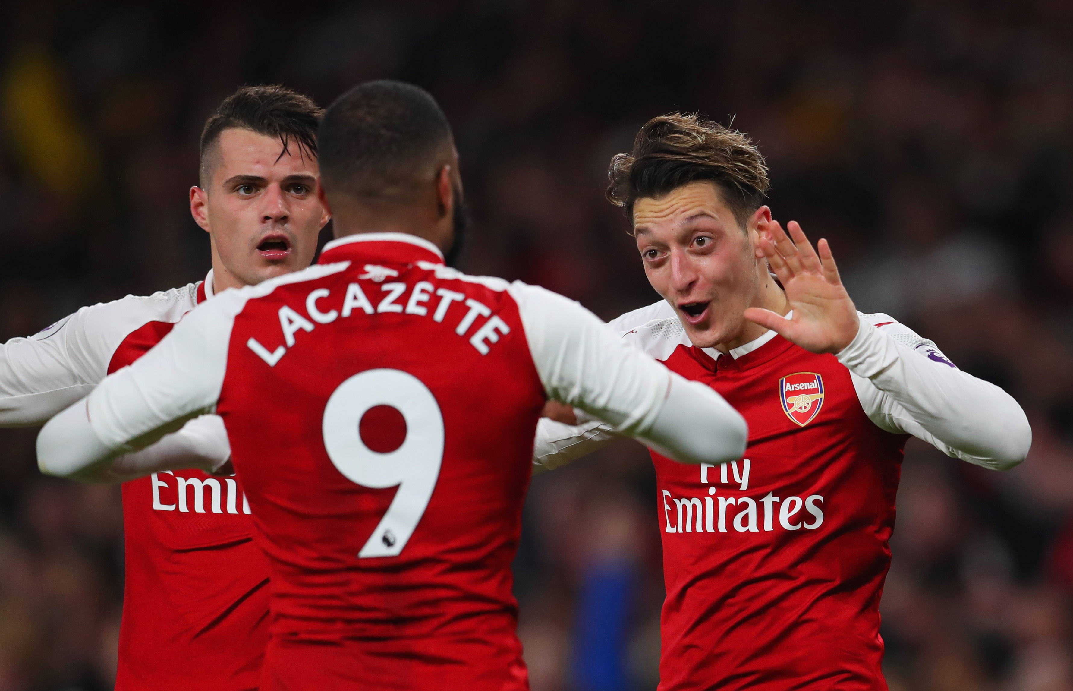 LONDON, ENGLAND - DECEMBER 22: Mesut Ozil of Arsenal (R) celebrates as he scores their third goal with Granit Xhaka and Alexandre Lacazette during the Premier League match between Arsenal and Liverpool at Emirates Stadium on December 22, 2017 in London, England. (Photo by Catherine Ivill/Getty Images)