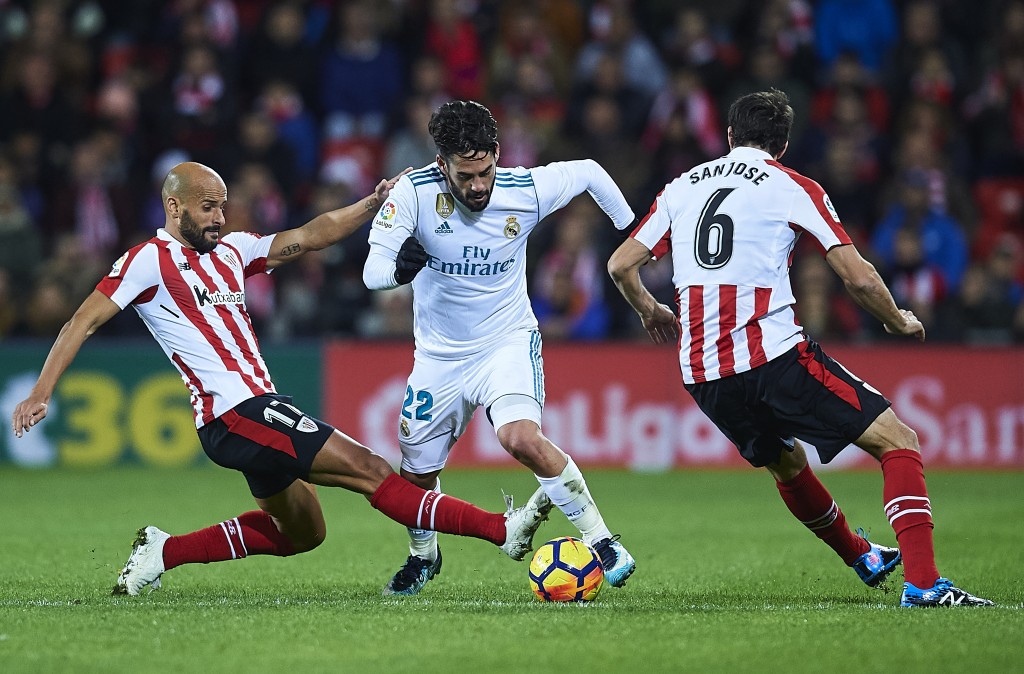 BILBAO, SPAIN - DECEMBER 02: Isco Alarcon of Real Madrid CF being fouled by Mikel Rico of Athletic Club (L) during the La Liga match between Athletic Club and Real Madrid at Estadio de San Mames on December 2, 2017 in Bilbao, Spain. (Photo by Juan Manuel Serrano Arce/Getty Images)