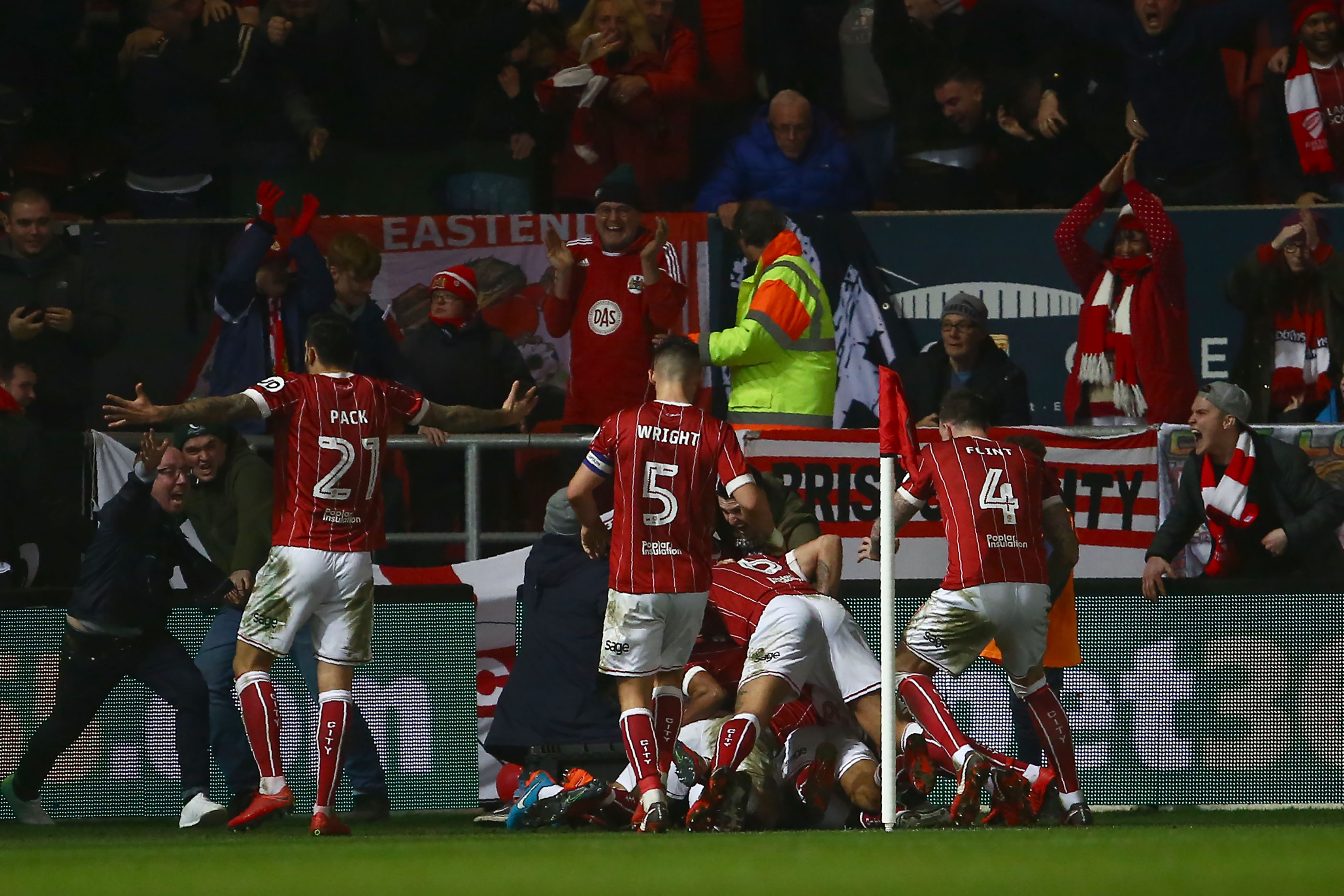 Bristol City's English midfielder Korey Smith celebrates with teammates scoring the second goal during the English League Cup quarter-final football match between Bristol City and Manchester United at Ashton Gate Stadium in Bristol, southwest England on December 20, 2017. / AFP PHOTO / Geoff CADDICK / RESTRICTED TO EDITORIAL USE. No use with unauthorized audio, video, data, fixture lists, club/league logos or 'live' services. Online in-match use limited to 75 images, no video emulation. No use in betting, games or single club/league/player publications.  /         (Photo credit should read GEOFF CADDICK/AFP/Getty Images)