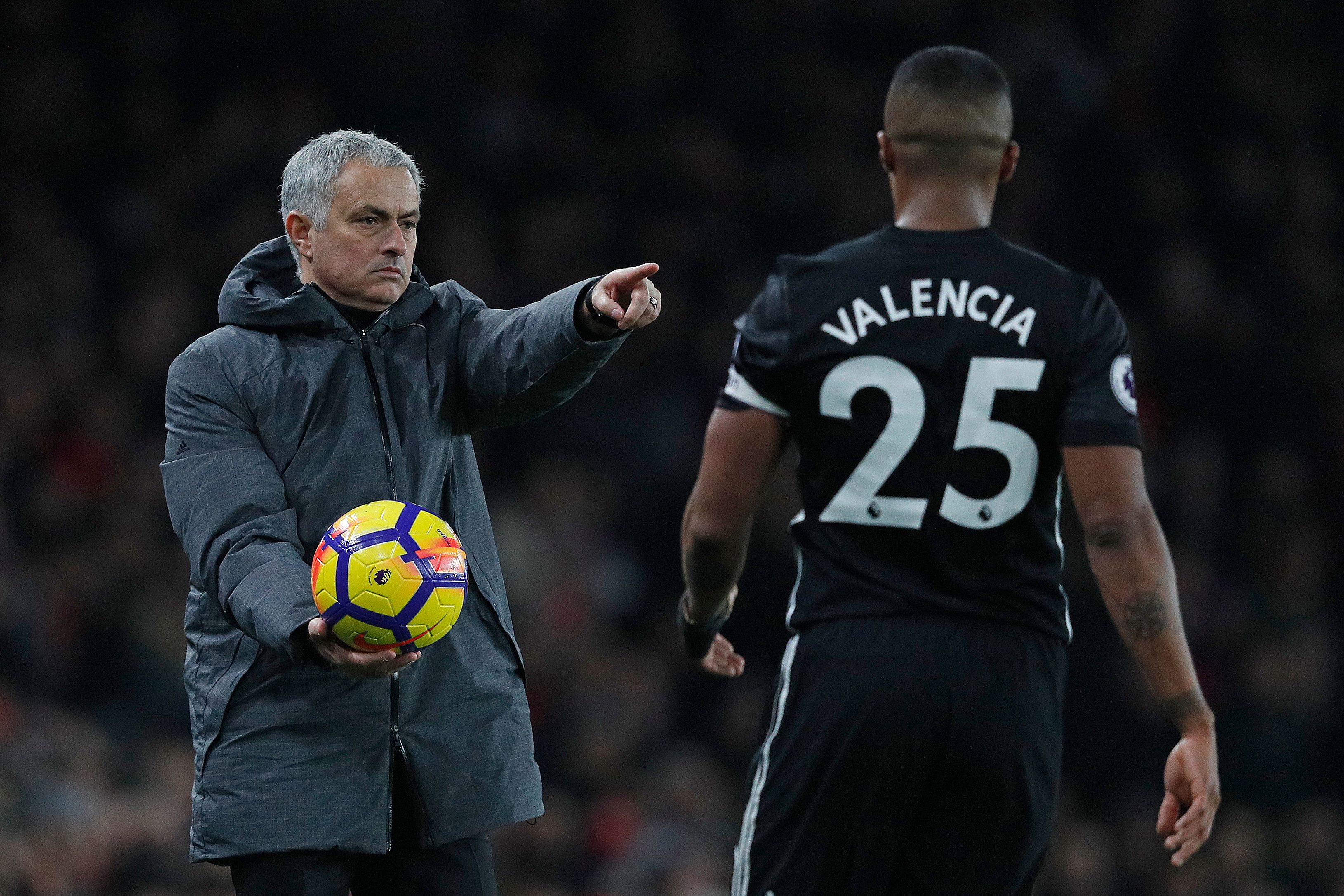 Manchester United's Portuguese manager Jose Mourinho (L) gestures as he gives the ball to Manchester United's Ecuadorian midfielder Antonio Valencia during the English Premier League football match between Arsenal and Manchester United at the Emirates Stadium in London on December 2, 2017. / AFP PHOTO / Adrian DENNIS / RESTRICTED TO EDITORIAL USE. No use with unauthorized audio, video, data, fixture lists, club/league logos or 'live' services. Online in-match use limited to 75 images, no video emulation. No use in betting, games or single club/league/player publications. / (Photo credit should read ADRIAN DENNIS/AFP/Getty Images)