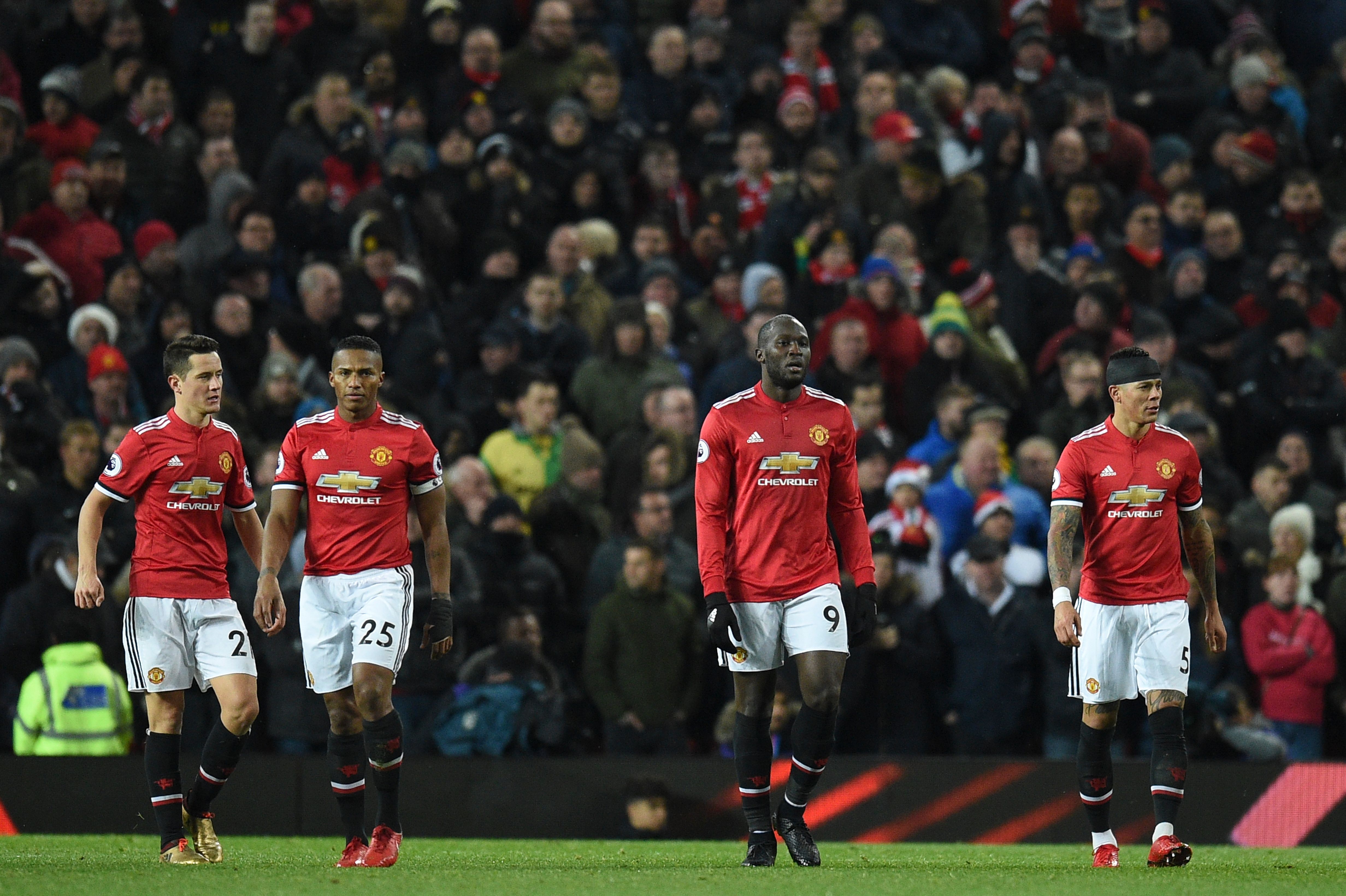 Manchester United's Belgian striker Romelu Lukaku (2R), Manchester United's Argentinian defender Marcos Rojo (R), Manchester United's Spanish midfielder Ander Herrera (L) and Manchester United's Ecuadorian midfielder Antonio Valencia (2L) react after Manchester City's first goal during the English Premier League football match between Manchester United and Manchester City at Old Trafford in Manchester, north west England, on December 10, 2017. / AFP PHOTO / Oli SCARFF / RESTRICTED TO EDITORIAL USE. No use with unauthorized audio, video, data, fixture lists, club/league logos or 'live' services. Online in-match use limited to 75 images, no video emulation. No use in betting, games or single club/league/player publications.  /         (Photo credit should read OLI SCARFF/AFP/Getty Images)