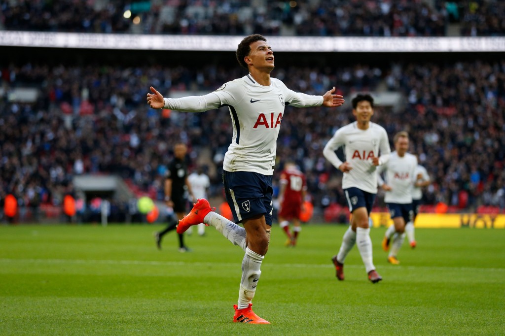 Tottenham Hotspur's English midfielder Dele Alli celebrates after scoring their third goal during the English Premier League football match between Tottenham Hotspur and Liverpool at Wembley Stadium in London, on October 22, 2017. / AFP PHOTO / IKIMAGES / Ian KINGTON / RESTRICTED TO EDITORIAL USE. No use with unauthorized audio, video, data, fixture lists, club/league logos or 'live' services. Online in-match use limited to 45 images, no video emulation. No use in betting, games or single club/league/player publications. / (Photo credit should read IAN KINGTON/AFP/Getty Images)