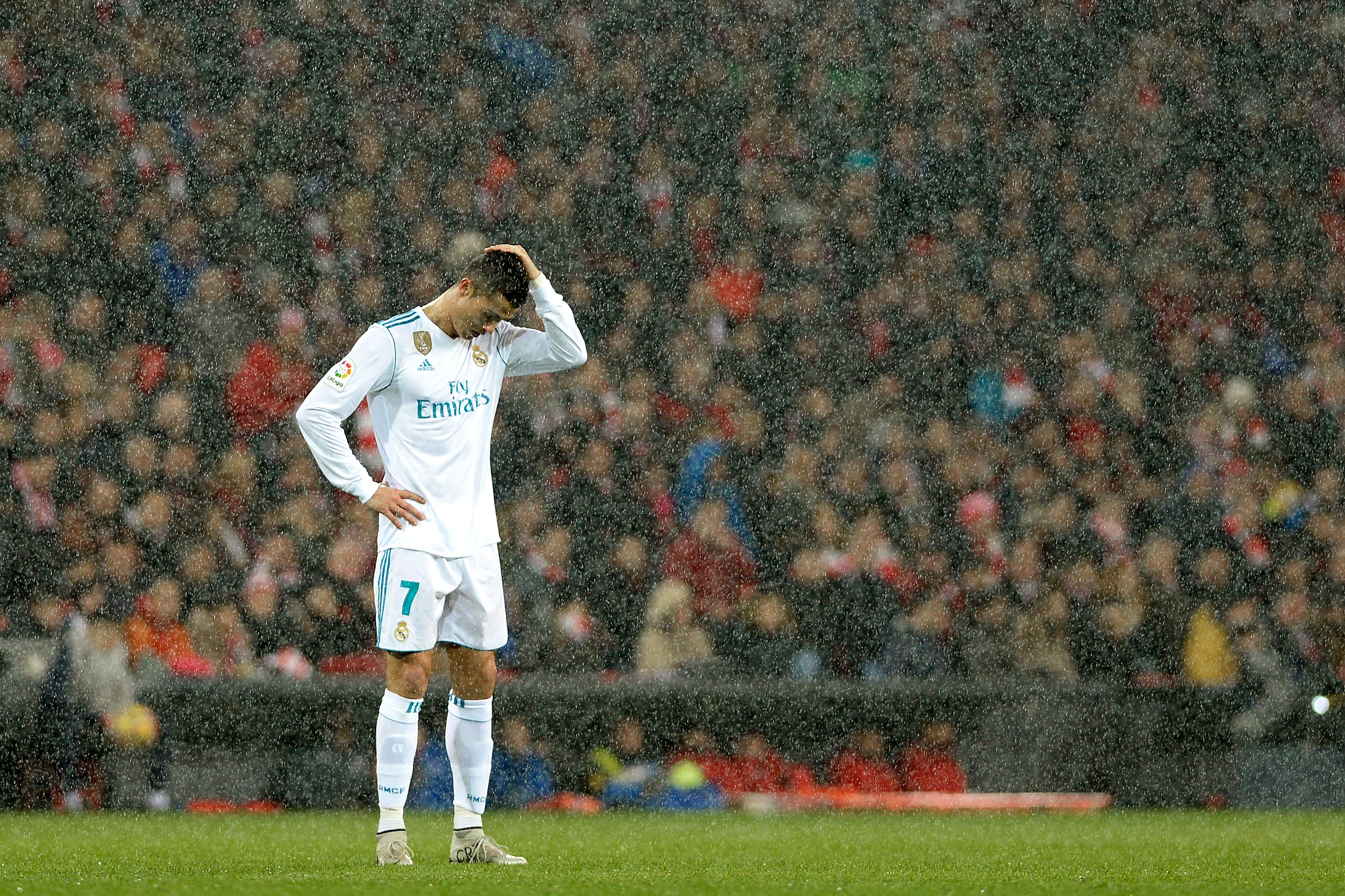 Real Madrid's Portuguese forward Cristiano Ronaldo reacts as snow falls during the Spanish league football match Athletic Club Bilbao vs Real Madrid CF at the San Mames stadium in Bilbao on December 2, 2017. / AFP PHOTO / Ander GILLENEA (Photo credit should read ANDER GILLENEA/AFP/Getty Images)