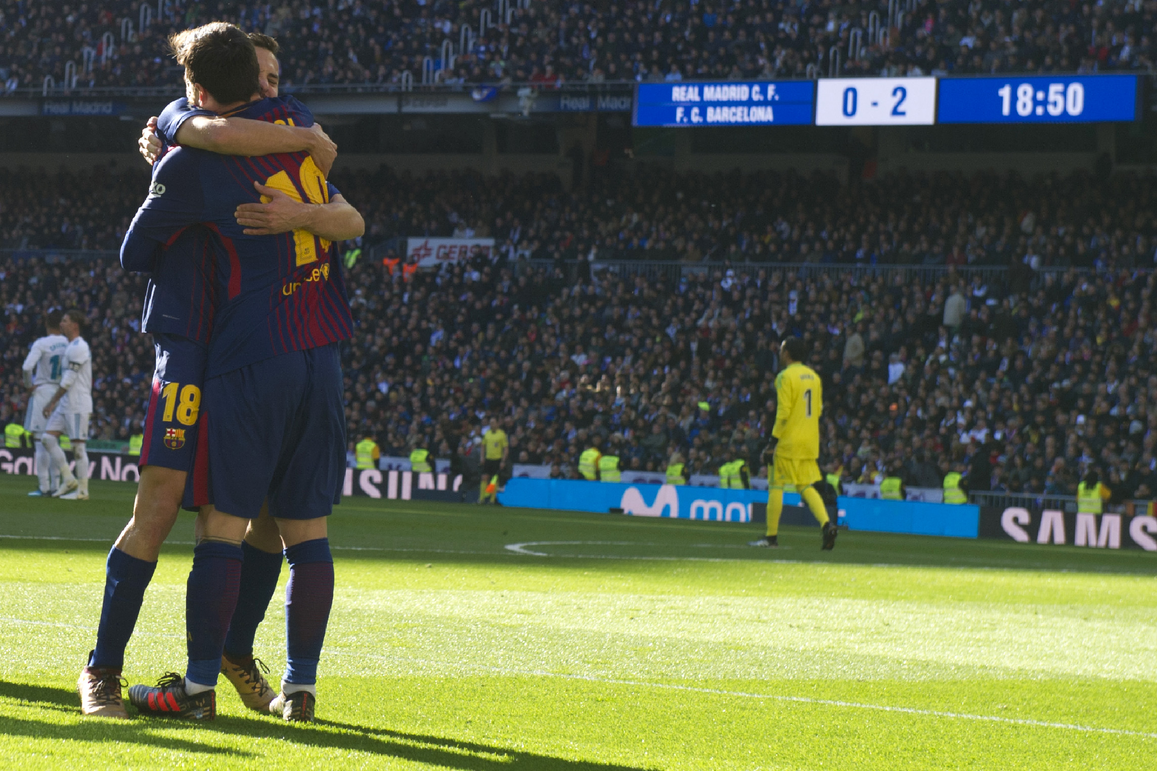 Barcelona's Argentinian forward Lionel Messi (R) celebrates with Barcelona's Spanish defender Jordi Alba  after scoring during the Spanish League "Clasico" football match Real Madrid CF vs FC Barcelona at the Santiago Bernabeu stadium in Madrid on December 23, 2017.  / AFP PHOTO / CURTO DE LA TORRE        (Photo credit should read CURTO DE LA TORRE/AFP/Getty Images)