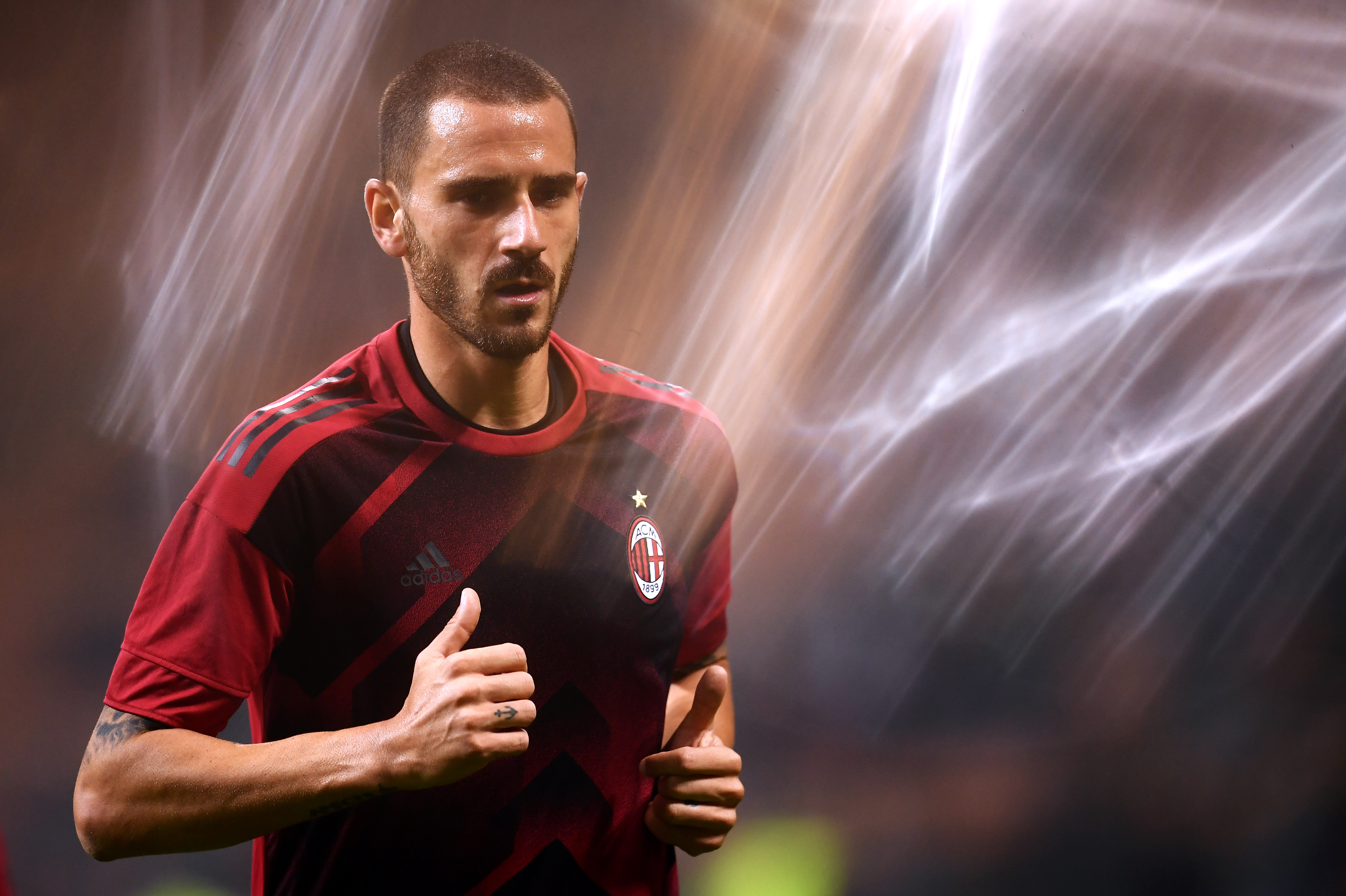 AC Milan's defender Leonardo Bonucci from Italy warms up before the UEFA Europa League football match AC Milan vs AEK Athens at the "San Siro Stadium" in Milan on October 19, 2017. / AFP PHOTO / MARCO BERTORELLO (Photo credit should read MARCO BERTORELLO/AFP/Getty Images)