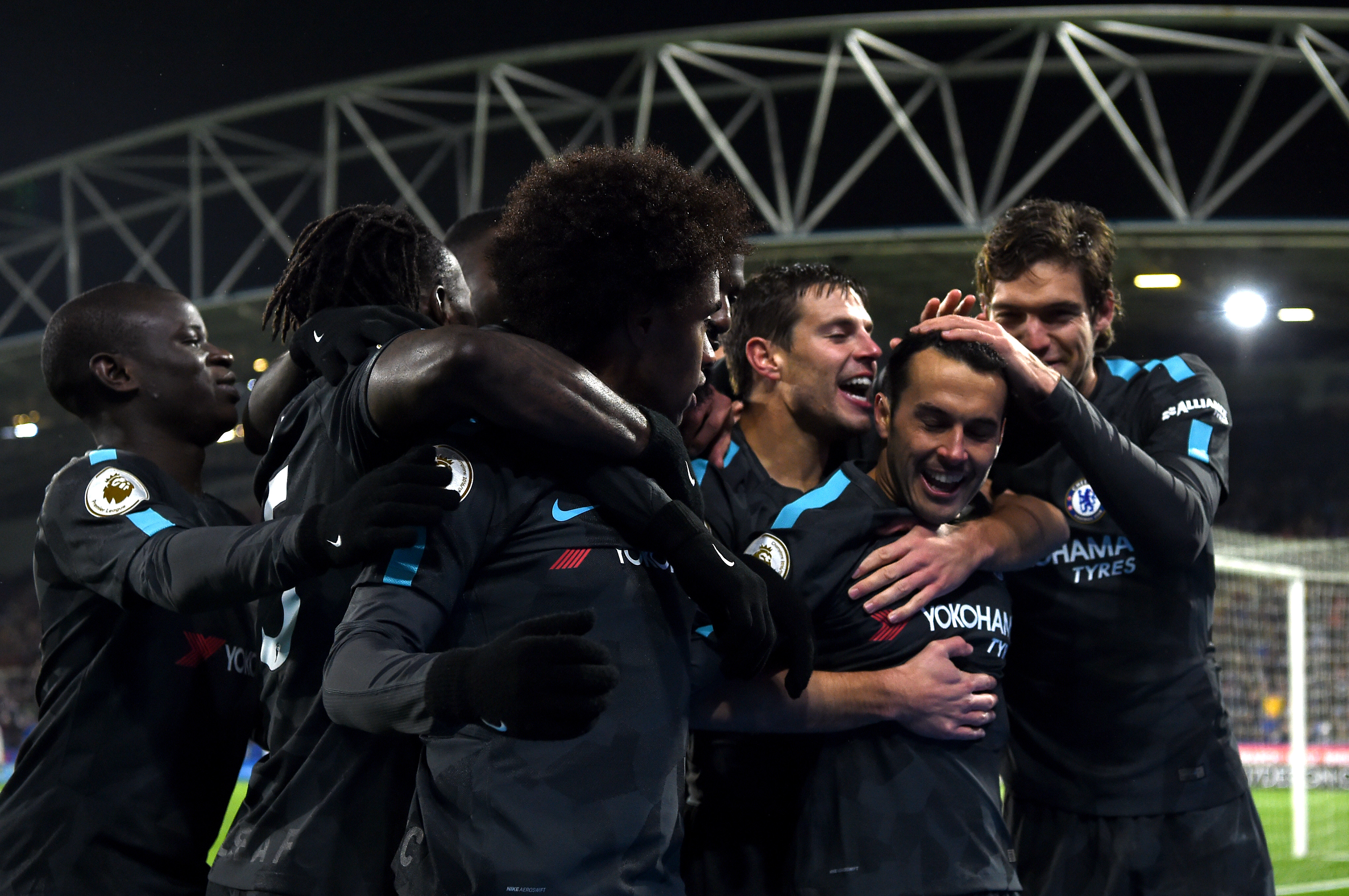 HUDDERSFIELD, ENGLAND - DECEMBER 12: Pedro of Chelsea celebrates after scoring his sides third goal with his teammates during the Premier League match between Huddersfield Town and Chelsea at John Smith's Stadium on December 12, 2017 in Huddersfield, England. (Photo by Laurence Griffiths/Getty Images)