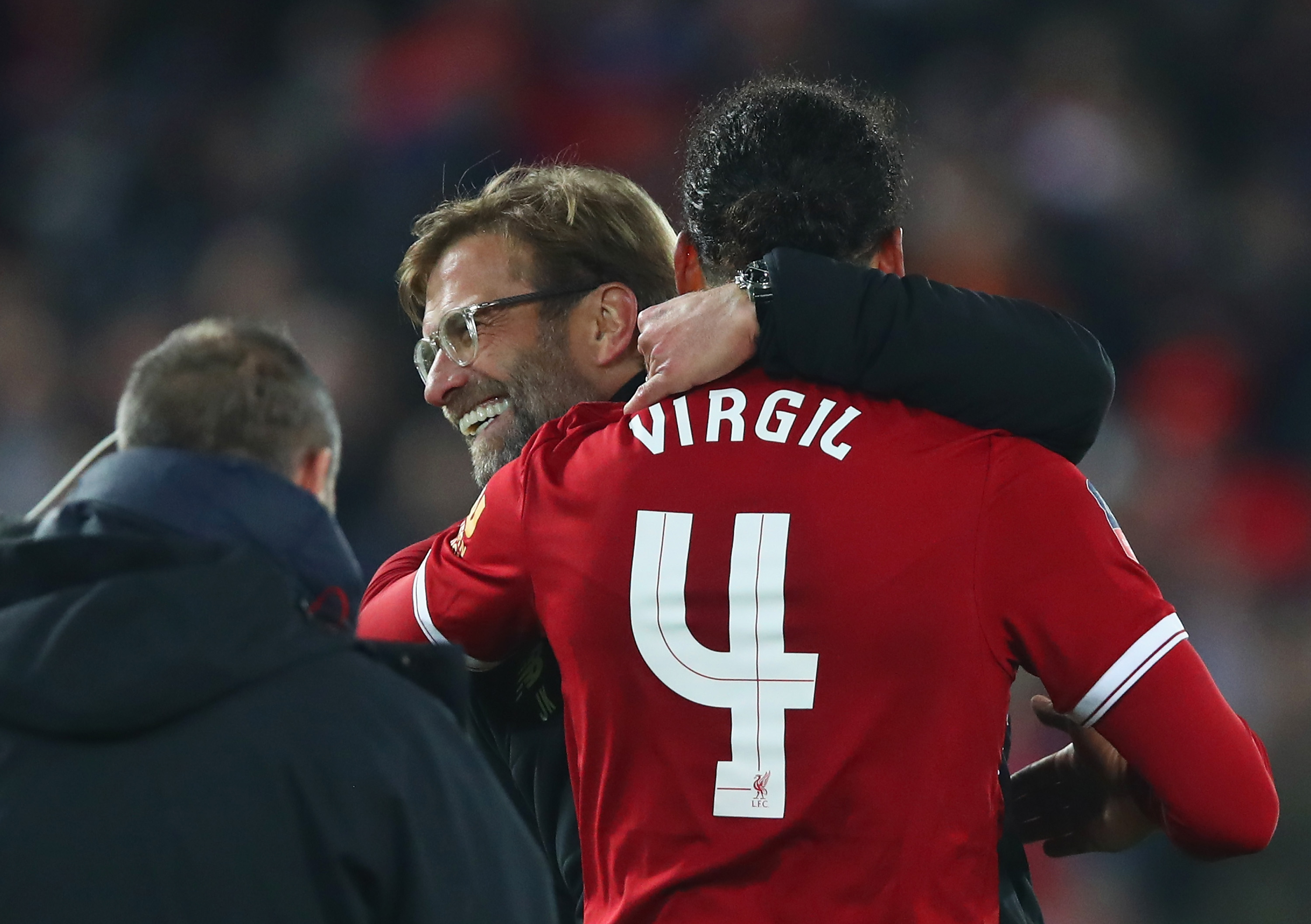 LIVERPOOL, ENGLAND - JANUARY 05: Virgil van Dijk of Liverpool celebrates victory with Jurgen Klopp, Manager of Liverpool after the Emirates FA Cup Third Round match between Liverpool and Everton at Anfield on January 5, 2018 in Liverpool, England. (Photo by Clive Brunskill/Getty Images)
