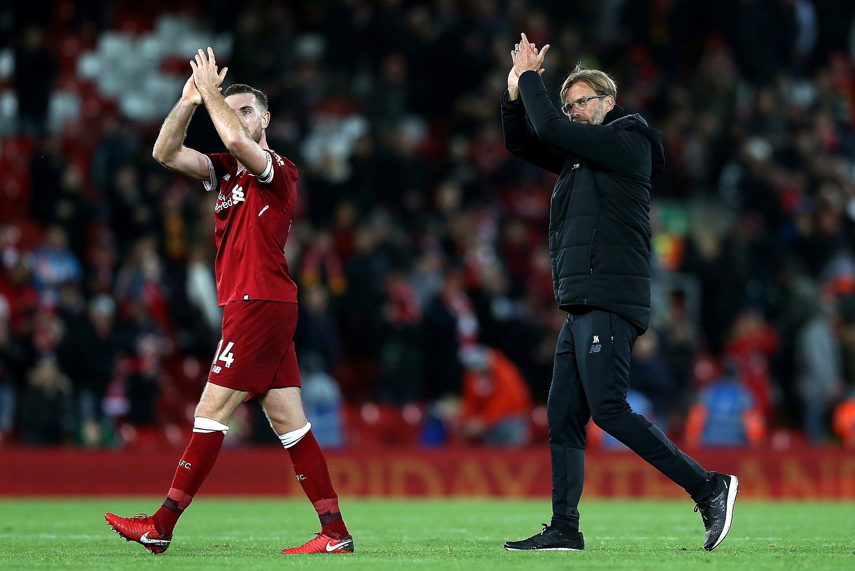 LIVERPOOL, ENGLAND - NOVEMBER 18: Manager Jurgen Klopp (R) and Jordan Henderson (L) of Liverpool applaud supporters after their 3-0 victory in the Premier League match between Liverpool and Southampton at Anfield on November 18, 2017 in Liverpool, England. (Photo by Jan Kruger/Getty Images)
