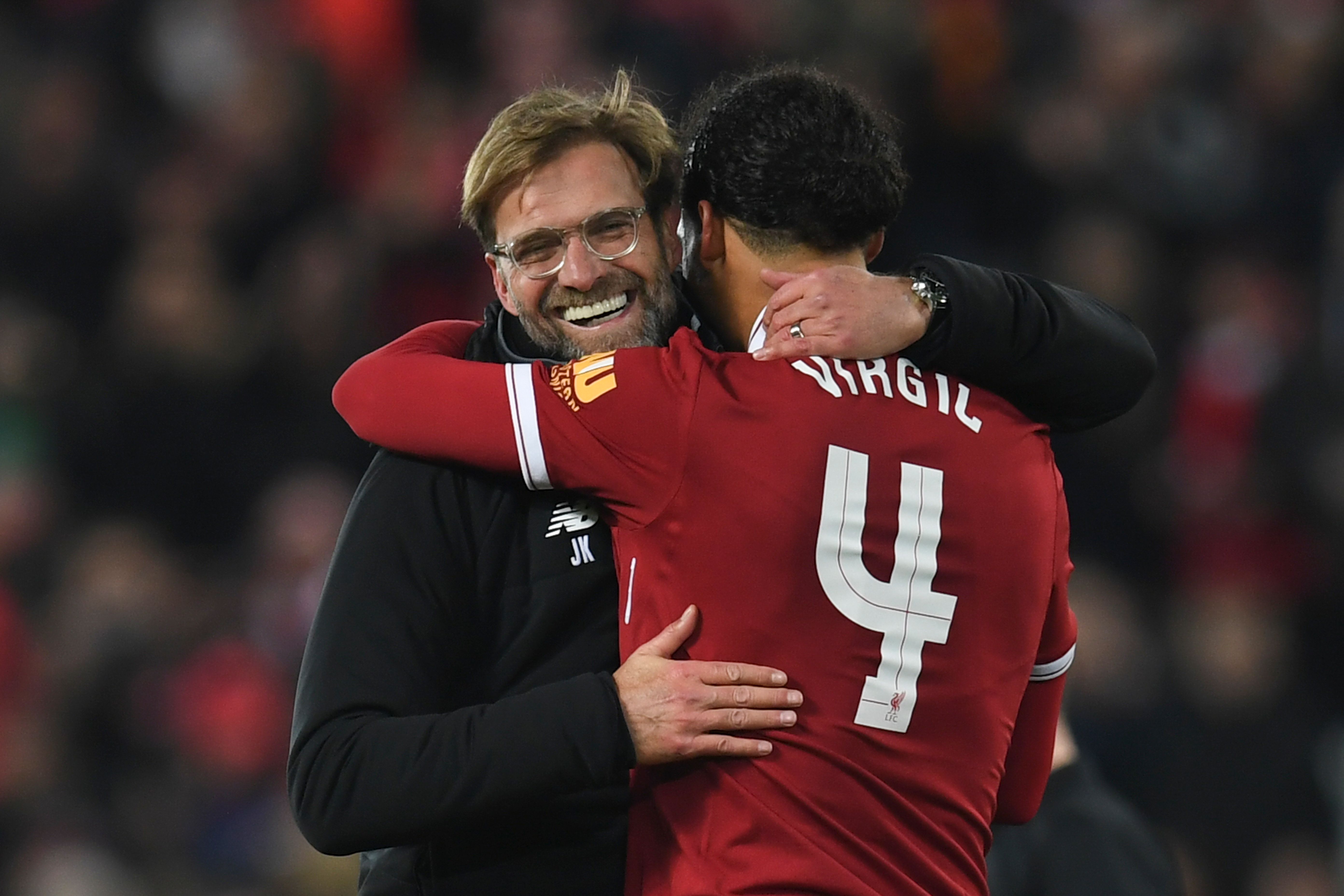 Liverpool's German manager Jurgen Klopp (L) hugs Liverpool's Dutch defender Virgil van Dijk (R) at the end of the English FA Cup third round football match between Liverpool and Everton at Anfield in Liverpool, north west England on January 5, 2018. / AFP PHOTO / Paul ELLIS / RESTRICTED TO EDITORIAL USE. No use with unauthorized audio, video, data, fixture lists, club/league logos or 'live' services. Online in-match use limited to 75 images, no video emulation. No use in betting, games or single club/league/player publications. / (Photo credit should read PAUL ELLIS/AFP/Getty Images)
