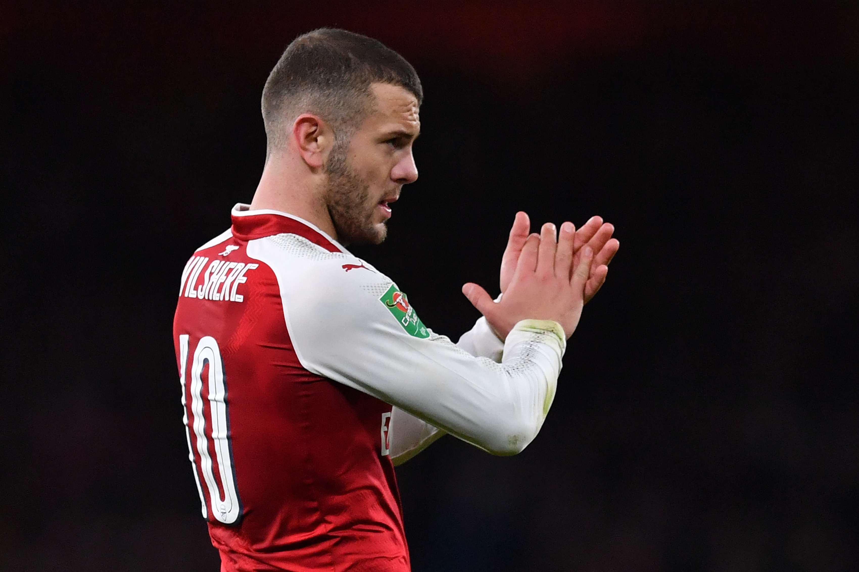 Arsenal's English midfielder Jack Wilshere gestures at the final whistle during the League Cup semi-final football match between Arsenal and Chelsea at the Emirates Stadium in London on January 24, 2018. / AFP PHOTO / Ben STANSALL / RESTRICTED TO EDITORIAL USE. No use with unauthorized audio, video, data, fixture lists, club/league logos or 'live' services. Online in-match use limited to 75 images, no video emulation. No use in betting, games or single club/league/player publications. / (Photo credit should read BEN STANSALL/AFP/Getty Images)