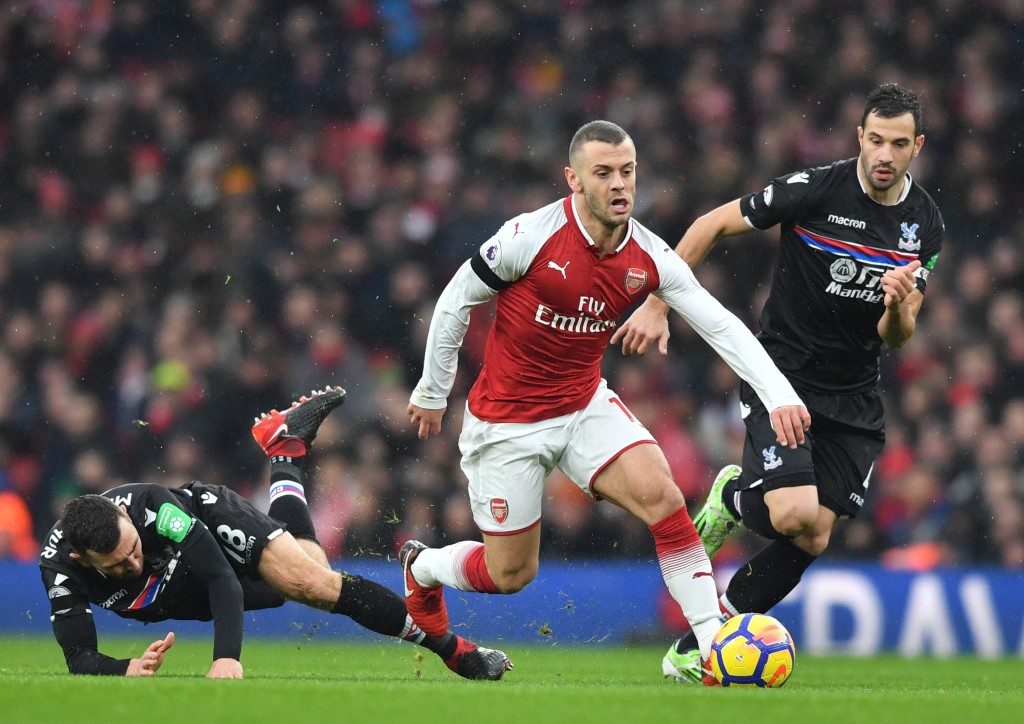 Arsenal's English midfielder Jack Wilshere (C) vies with Crystal Palace's Serbian midfielder Luka Milivojevic (R) during the English Premier League football match between Arsenal and Crystal Palace at the Emirates Stadium in London on January 20, 2018. / AFP PHOTO / Ben STANSALL / RESTRICTED TO EDITORIAL USE. No use with unauthorized audio, video, data, fixture lists, club/league logos or 'live' services. Online in-match use limited to 75 images, no video emulation. No use in betting, games or single club/league/player publications. / (Photo credit should read BEN STANSALL/AFP/Getty Images)