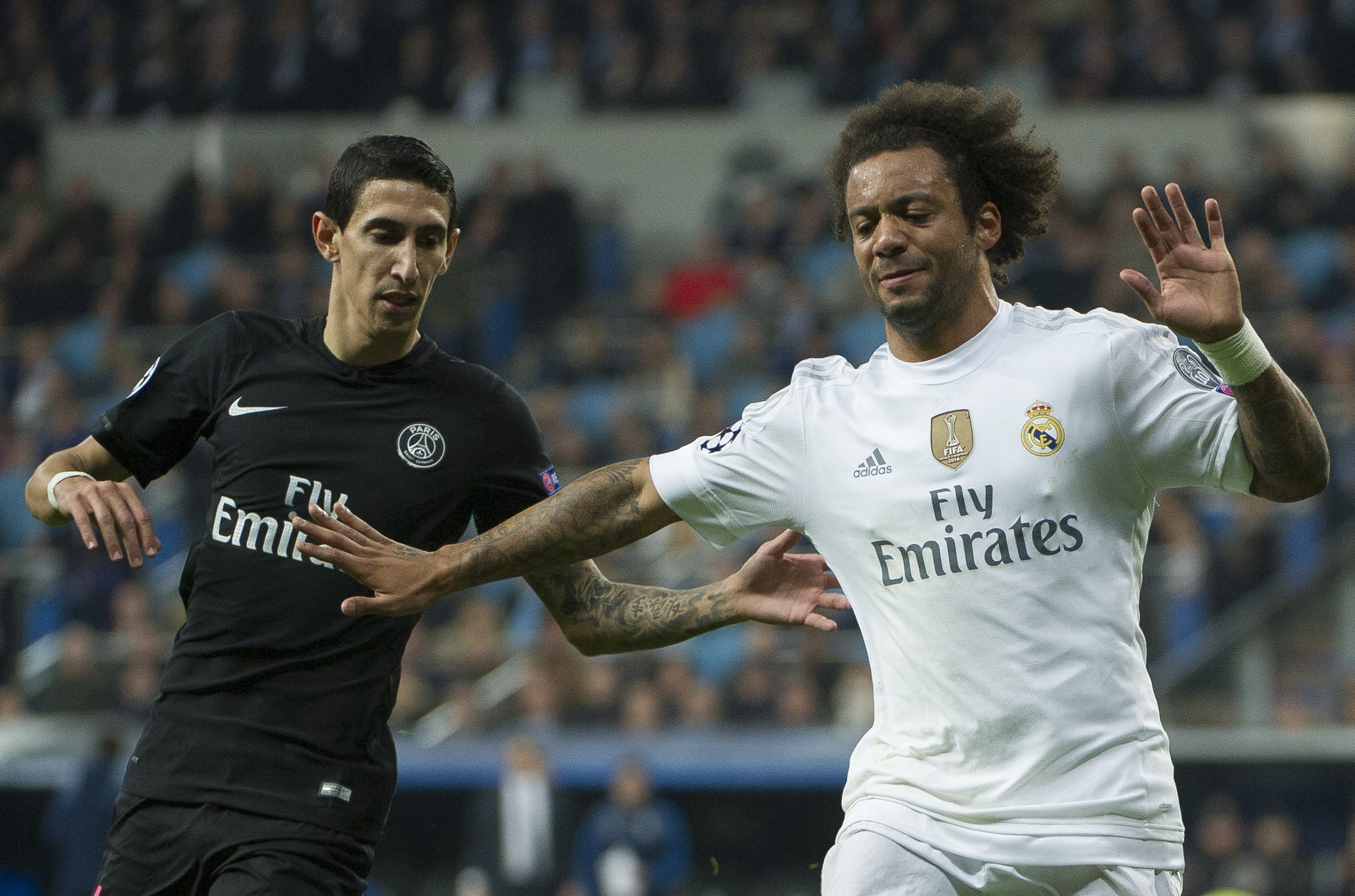 Paris Saint-Germain's Argentinean midfielder Angel Di Maria (L) vies with Real Madrid's Brazilian defender Marcelo injured in the play during the UEFA Champions League group stage football match Real Madrid CF vs Paris Saint-Germain (PSG) at the Santiago Bernabeu stadium in Madrid on November 3, 2015. AFP PHOTO / CURTO DE LA TORRE        (Photo credit should read CURTO DE LA TORRE/AFP/Getty Images)