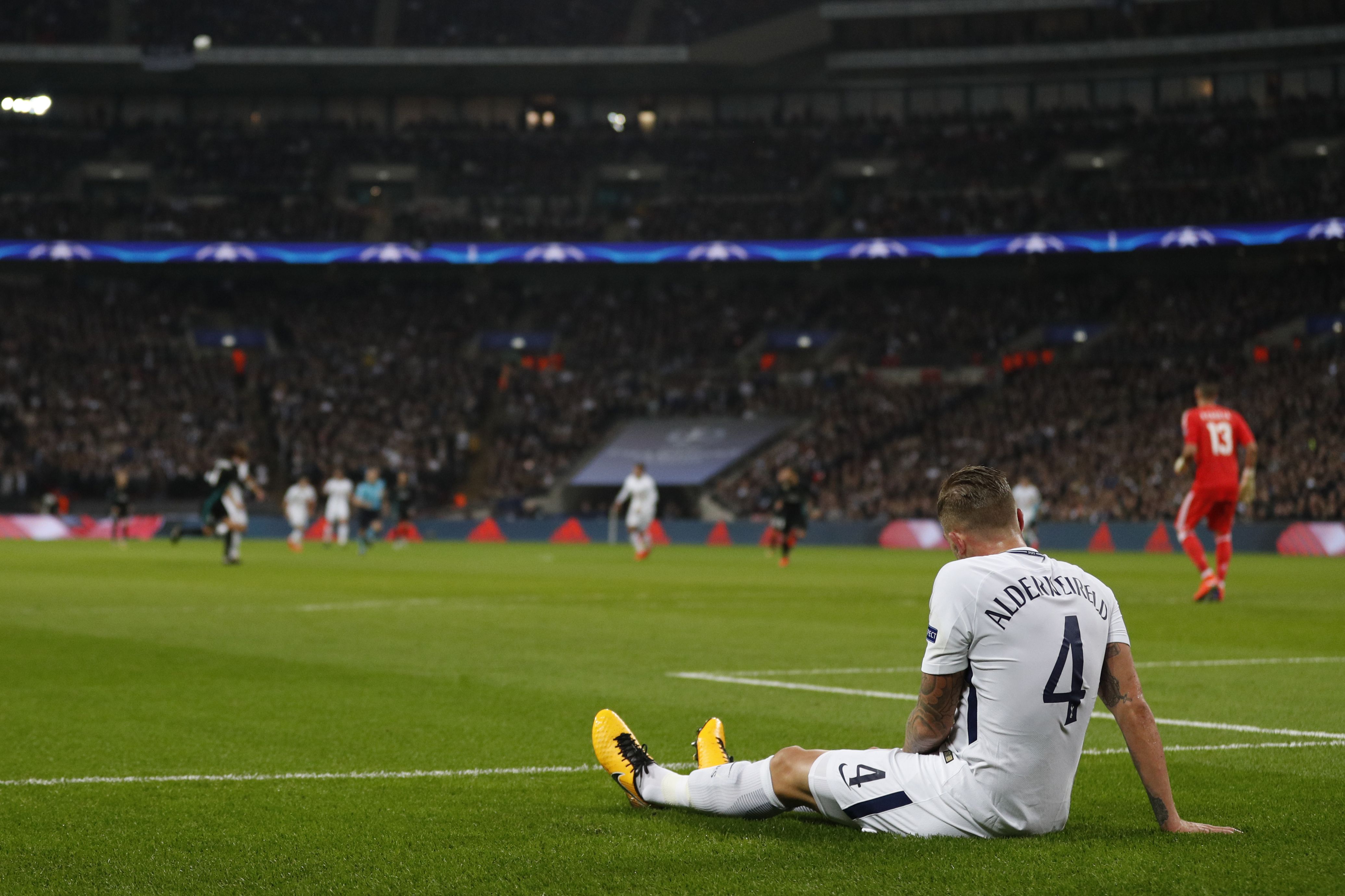 Tottenham Hotspur's Belgian defender Toby Alderweireld lies injured during the UEFA Champions League Group H football match between Tottenham Hotspur and Real Madrid at Wembley Stadium in London, on November 1, 2017. / AFP PHOTO / Adrian DENNIS (Photo credit should read ADRIAN DENNIS/AFP/Getty Images)