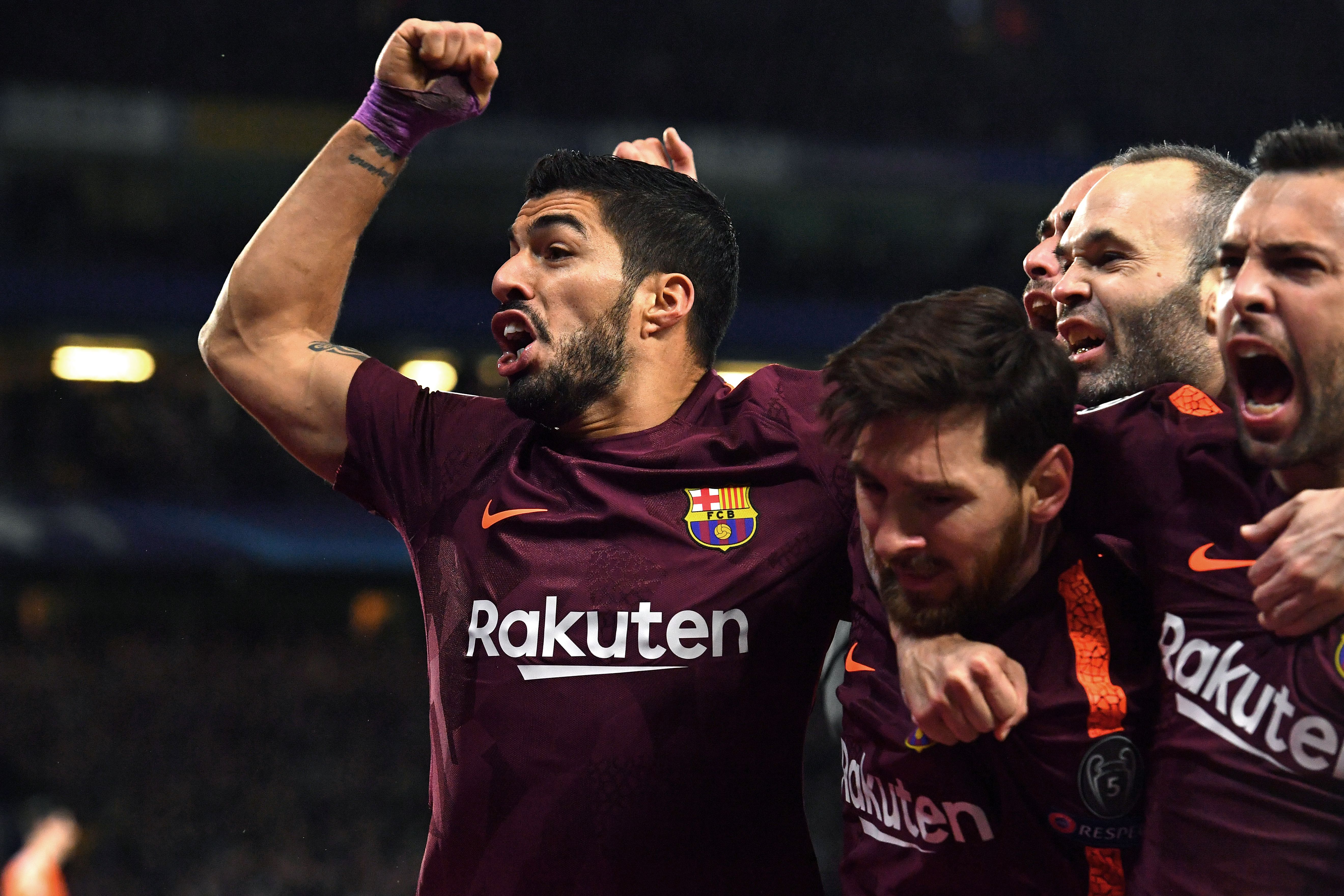 TOPSHOT - Barcelona's Argentinian striker Lionel Messi (C) celebrates with Barcelona's Uruguayan striker Luis Suarez (L) and teammates after scoring their first goal during the first leg of the UEFA Champions League round of 16 football match between Chelsea and Barcelona at Stamford Bridge stadium in London on February 20, 2018. / AFP PHOTO / Ben STANSALL (Photo credit should read BEN STANSALL/AFP/Getty Images)