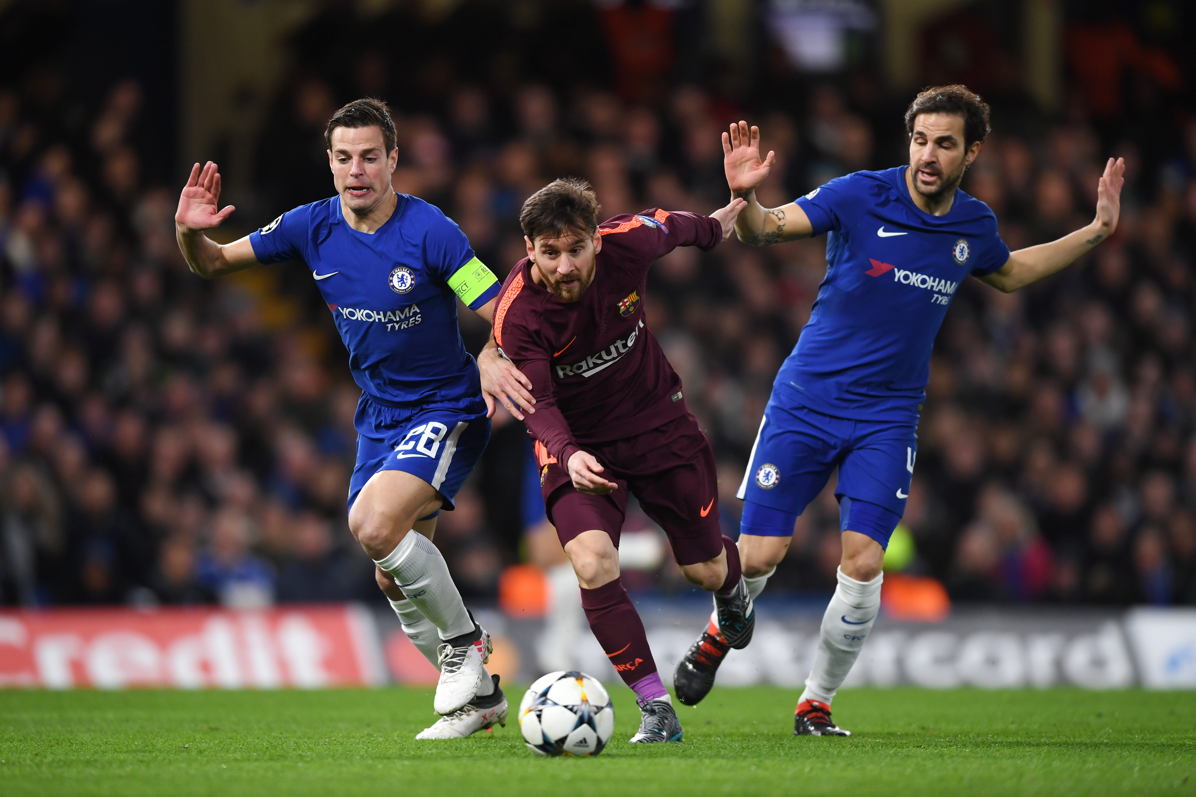 LONDON, ENGLAND - FEBRUARY 20: Lionel Messi of Barcelona is challenged by Cesar Azpilicueta of Chelsea and Cesc Fabregas of Chelsea during the UEFA Champions League Round of 16 First Leg match between Chelsea FC and FC Barcelona at Stamford Bridge on February 20, 2018 in London, United Kingdom. (Photo by Shaun Botterill/Getty Images,)