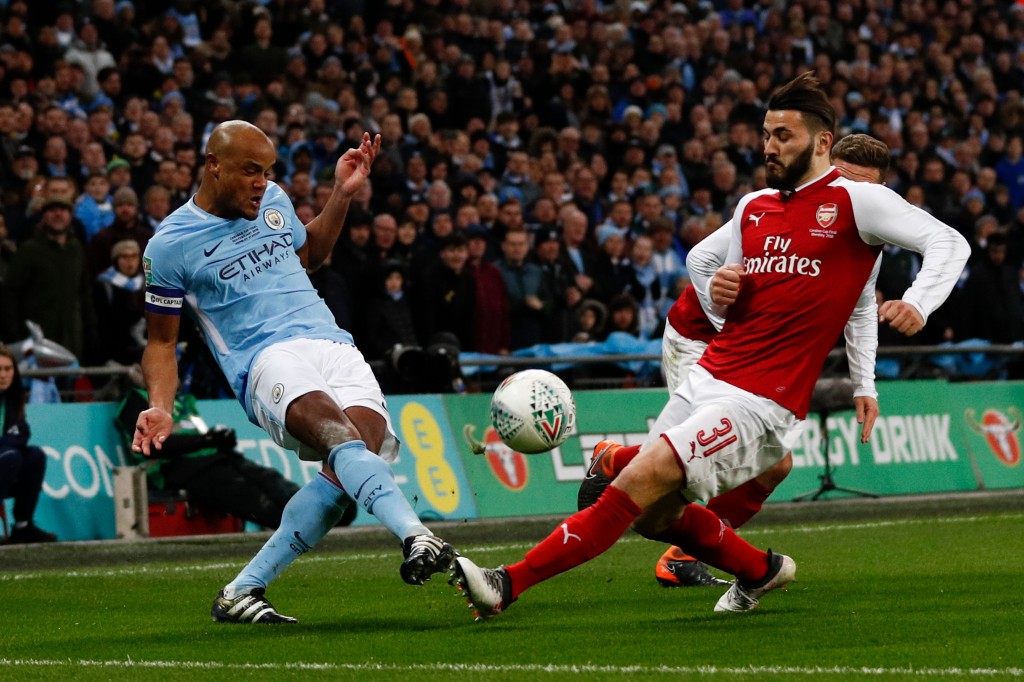 Manchester City's Belgian defender Vincent Kompany (L) vies with Arsenal's German-born Bosnian defender Sead Kolasinac during the English League Cup final football match between Manchester City and Arsenal at Wembley stadium in north London on February 25, 2018. / AFP PHOTO / Adrian DENNIS / RESTRICTED TO EDITORIAL USE. No use with unauthorized audio, video, data, fixture lists, club/league logos or 'live' services. Online in-match use limited to 75 images, no video emulation. No use in betting, games or single club/league/player publications. / (Photo credit should read ADRIAN DENNIS/AFP/Getty Images)