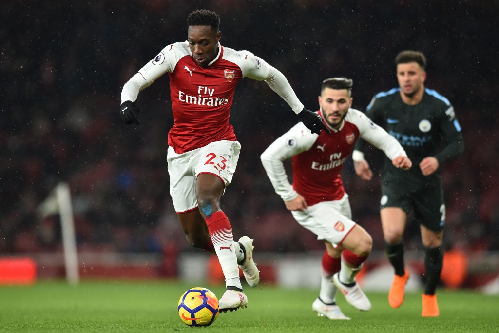 Arsenal's English striker Danny Welbeck runs with the ball during the English Premier League football match between Arsenal and Manchester City at the Emirates Stadium in London on March 1, 2018. / AFP PHOTO / Glyn KIRK / RESTRICTED TO EDITORIAL USE. No use with unauthorized audio, video, data, fixture lists, club/league logos or 'live' services. Online in-match use limited to 75 images, no video emulation. No use in betting, games or single club/league/player publications. / (Photo credit should read GLYN KIRK/AFP/Getty Images)