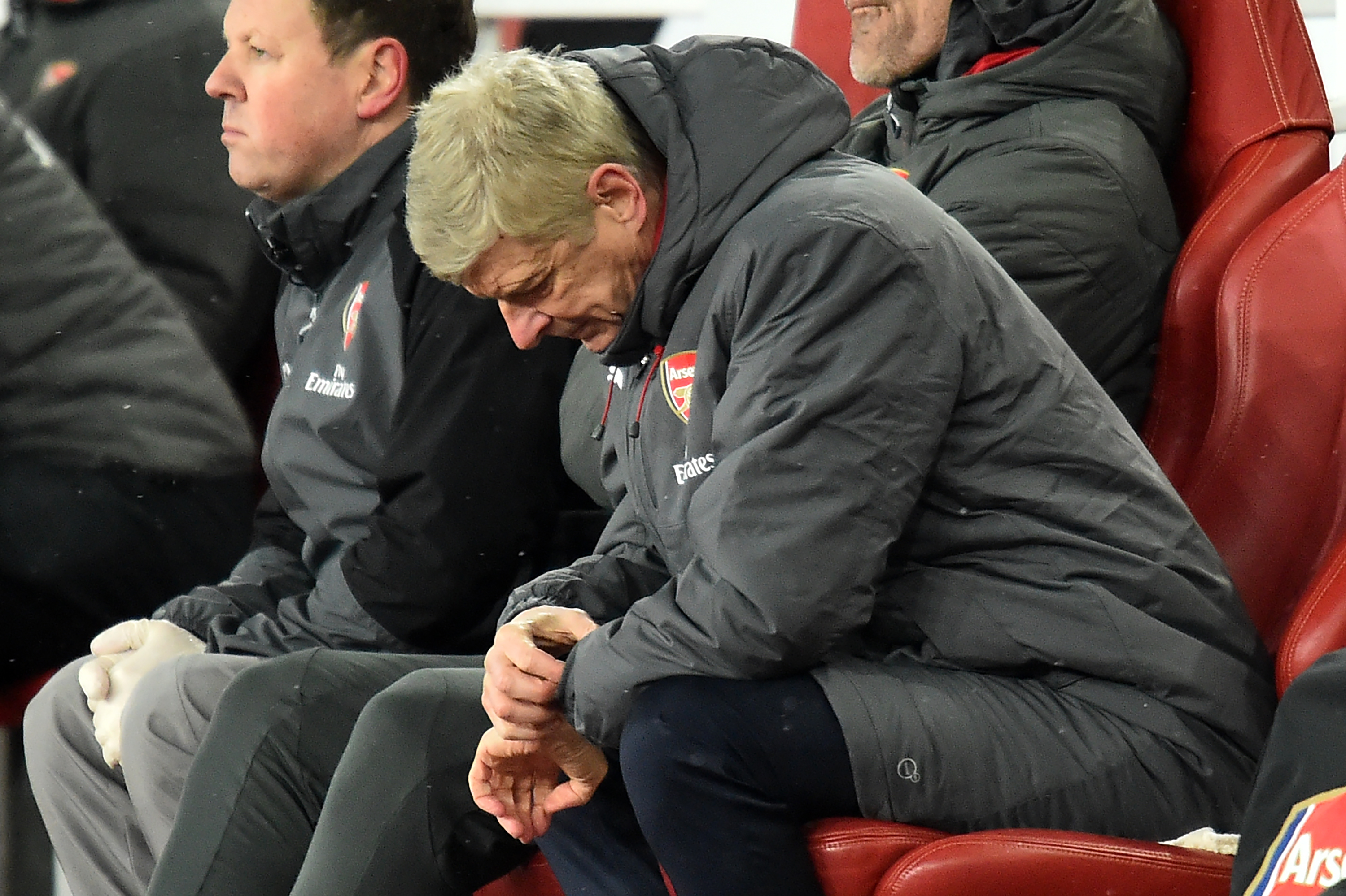 Arsenal's French manager Arsene Wenger checks his watch during the English Premier League football match between Arsenal and Manchester City at the Emirates Stadium in London on March 1, 2018.  / AFP PHOTO / Glyn KIRK / RESTRICTED TO EDITORIAL USE. No use with unauthorized audio, video, data, fixture lists, club/league logos or 'live' services. Online in-match use limited to 75 images, no video emulation. No use in betting, games or single club/league/player publications.  /         (Photo credit should read GLYN KIRK/AFP/Getty Images)